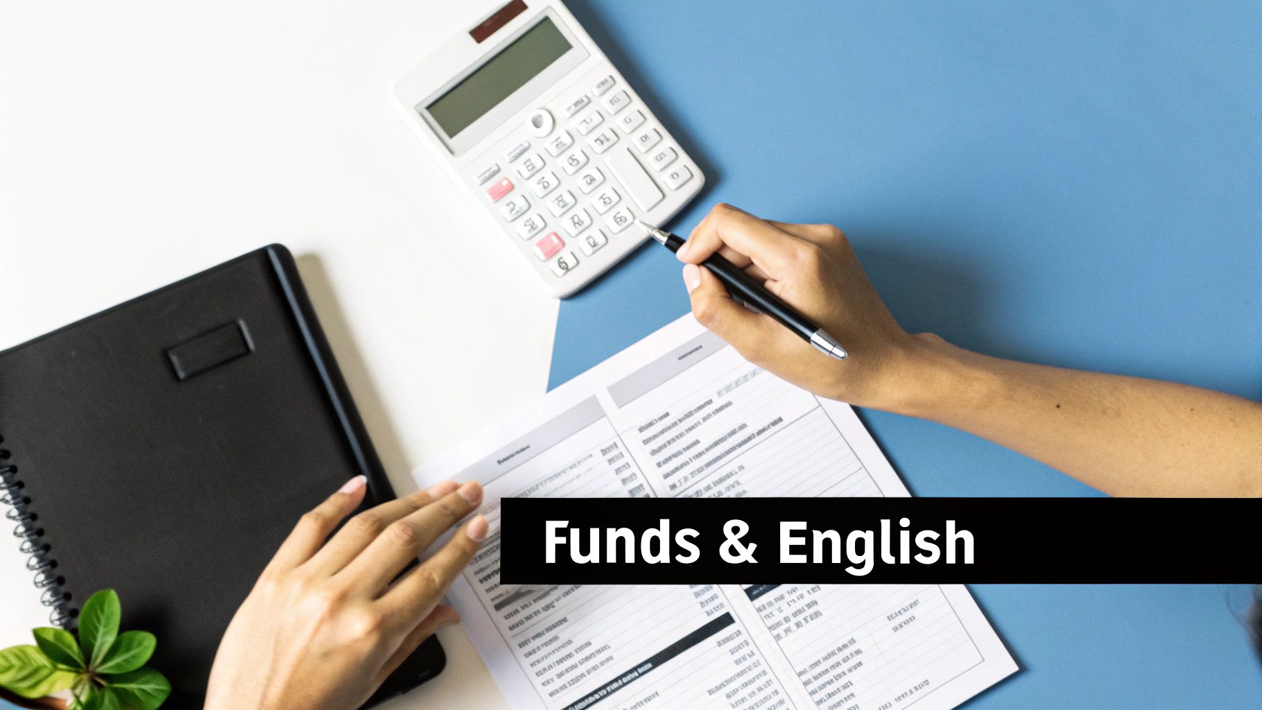 Overhead view of two people working on a desk with a calculator, documents, and a notebook.