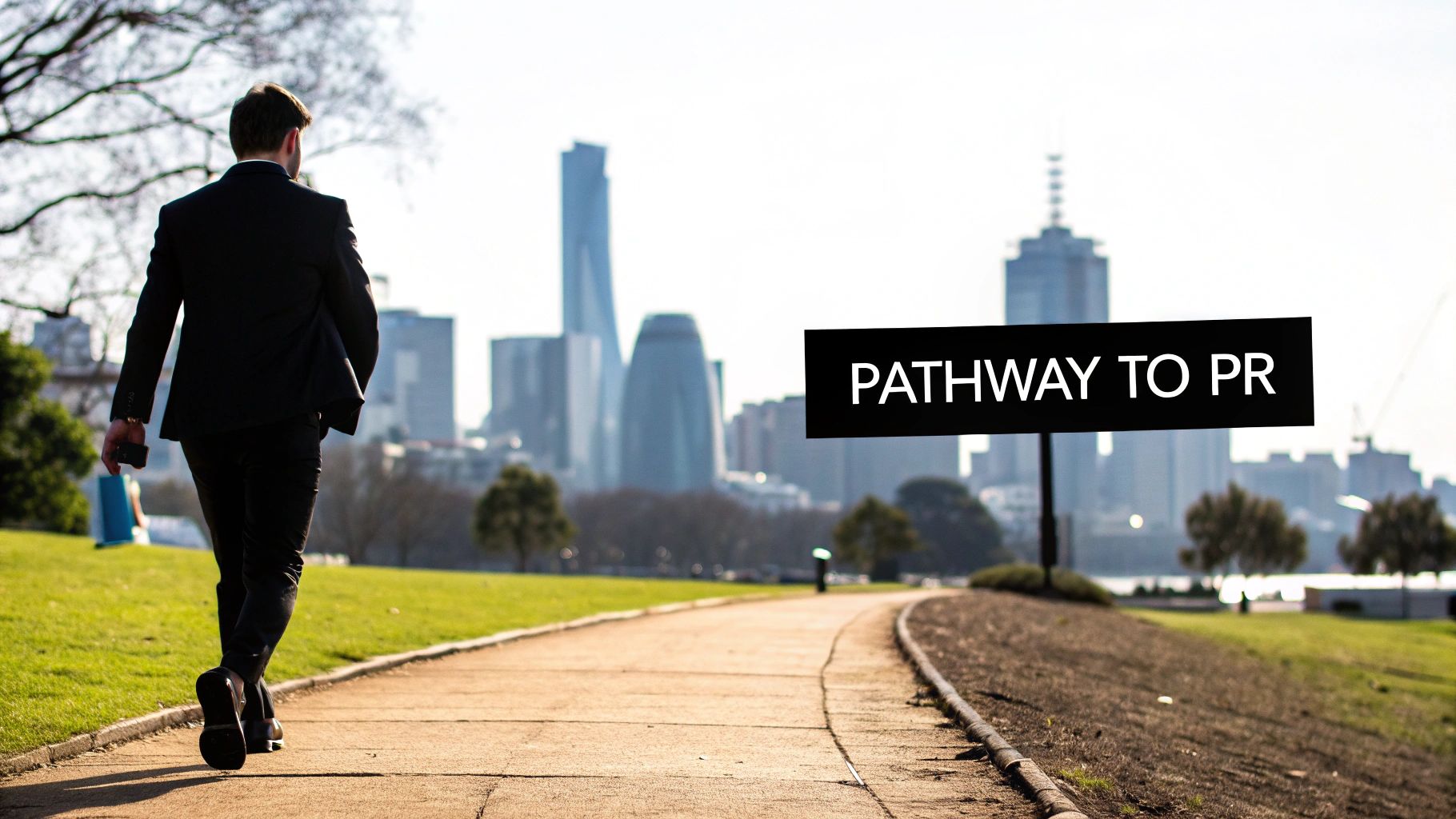 A man in a suit walks on a paved path towards a city skyline, passing a signpost that reads 'PATHWAY TO PR'.