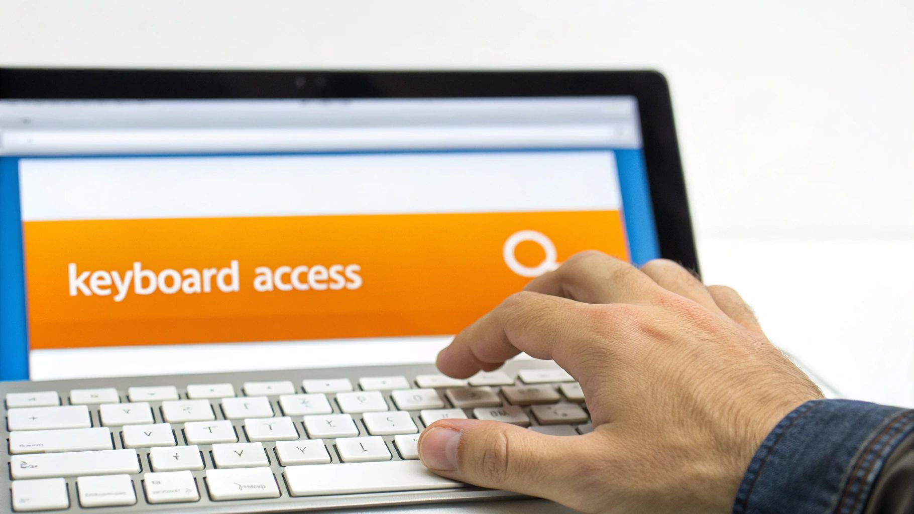 A person's hand types on a laptop keyboard displaying 'keyboard access' on the screen.