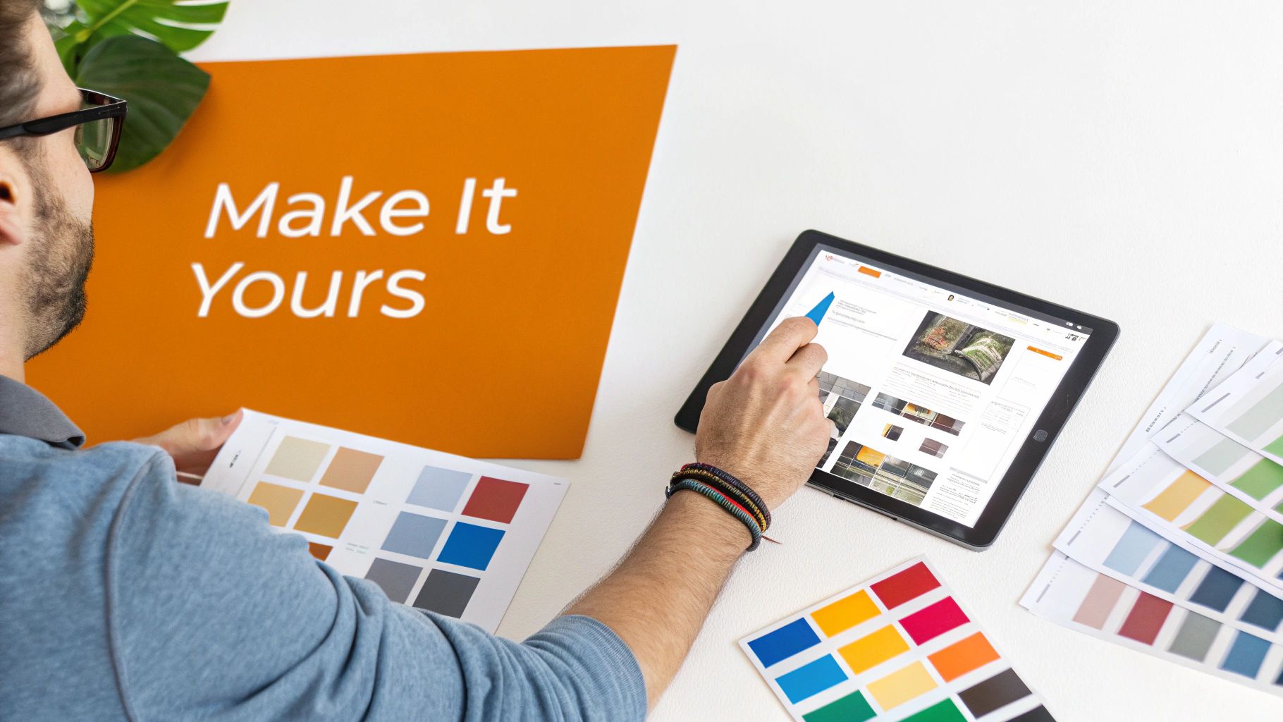 A person holds color swatches and uses a tablet to customize designs, surrounded by various color palettes.