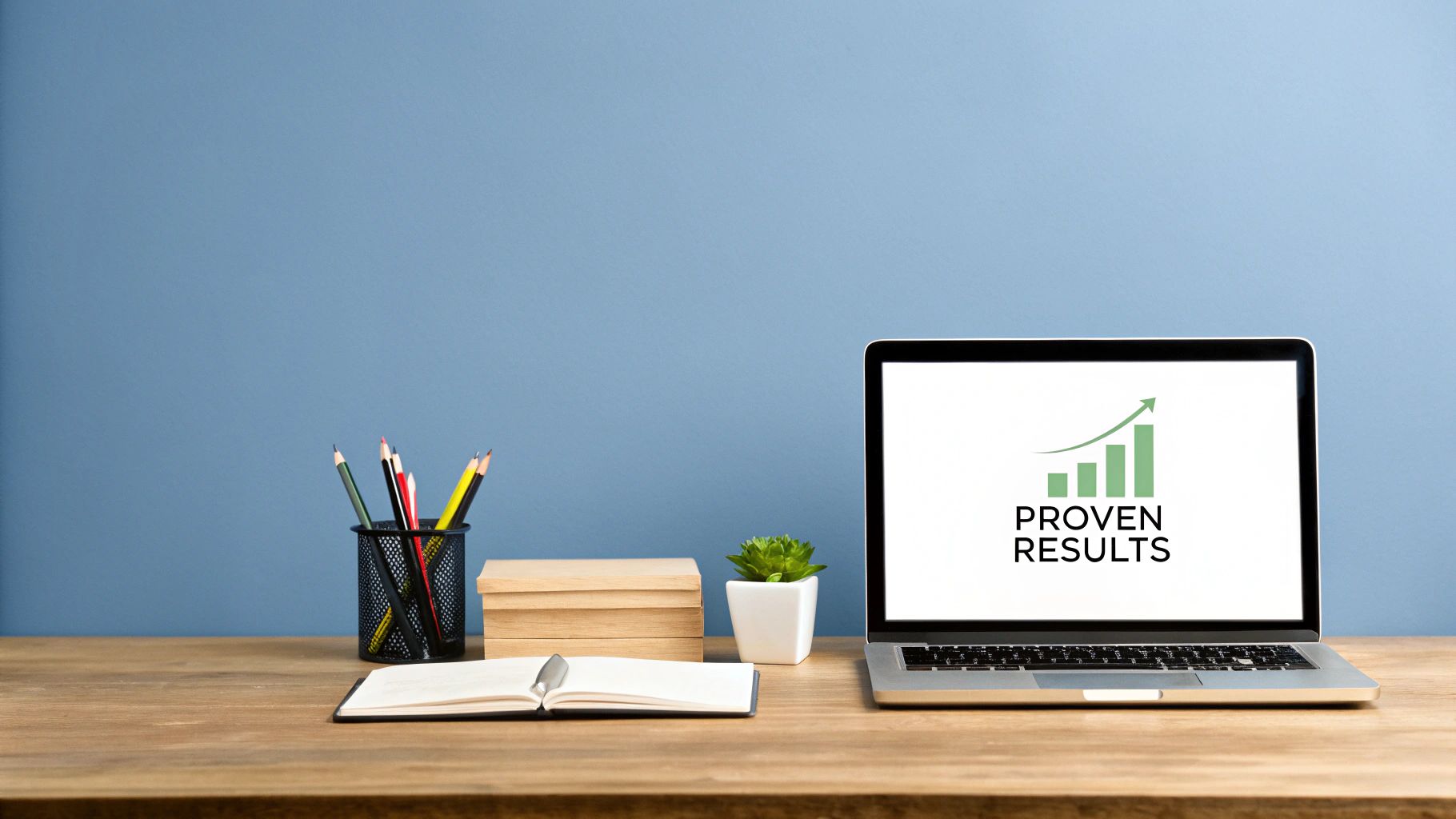 A tidy office desk featuring a laptop screen with "PROVEN RESULTS" and a growth chart.