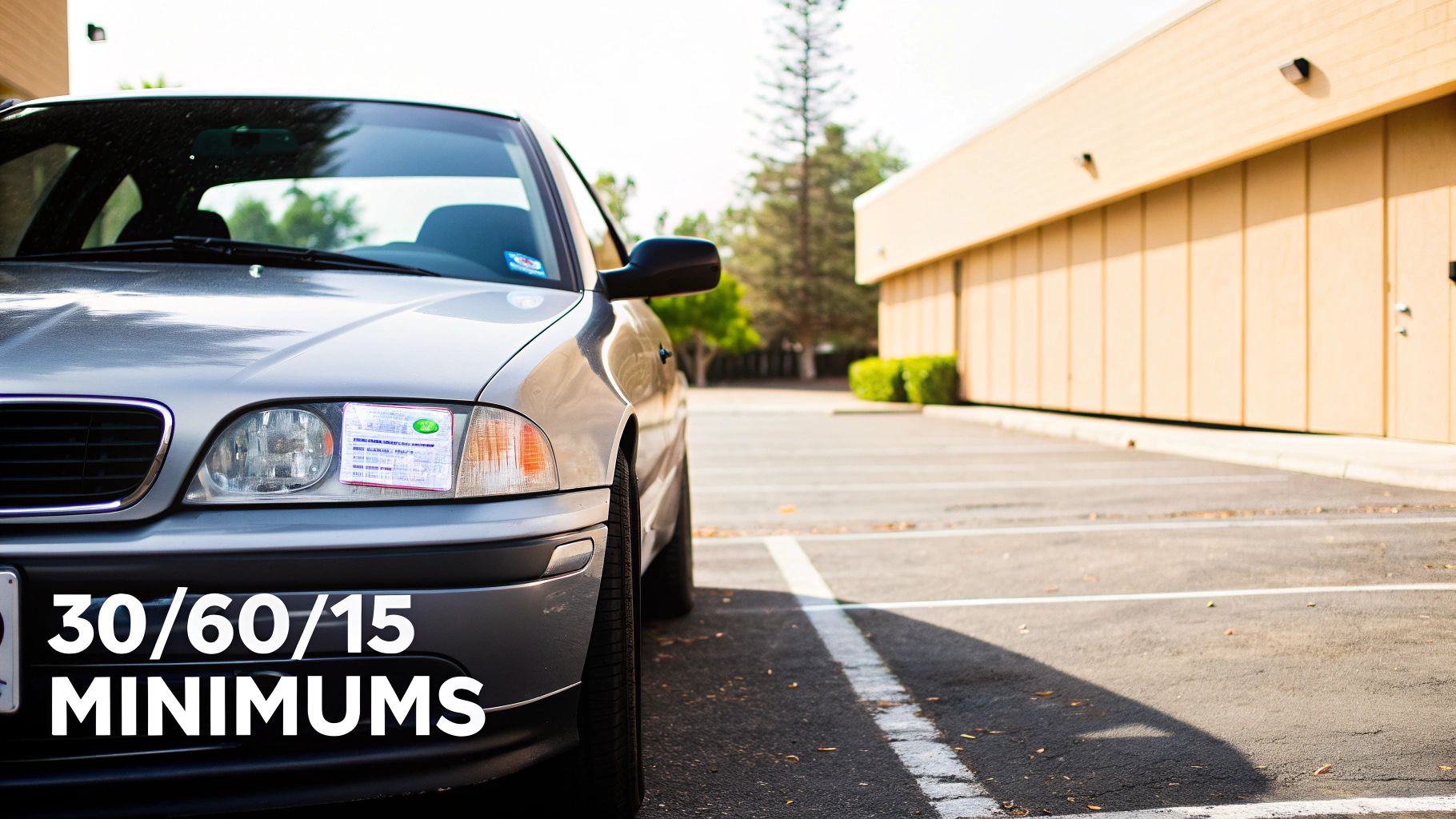 Silver sedan parked in lot displaying California minimum auto insurance requirements sticker on windshield