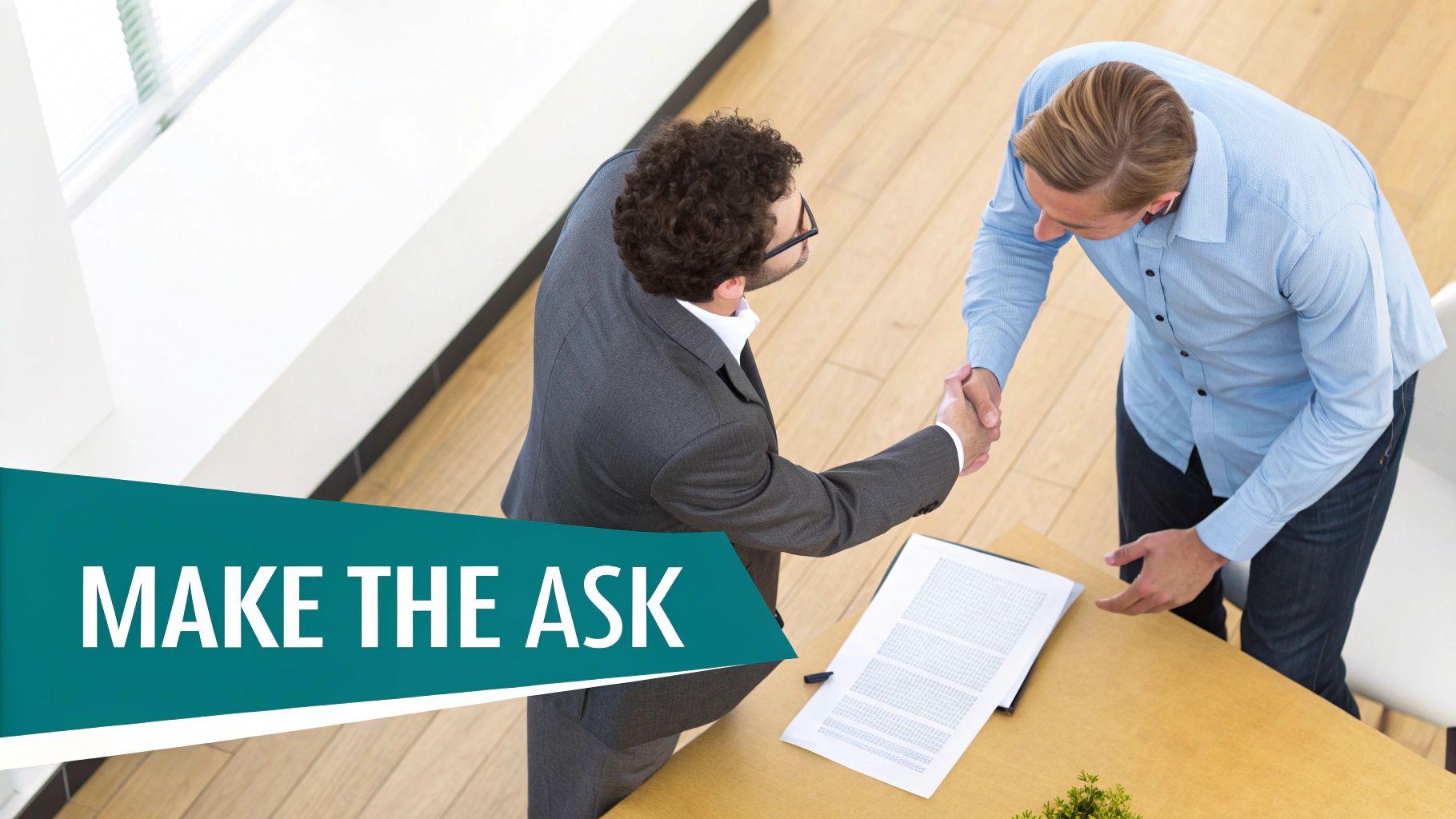 Two professionals shaking hands and finalizing a contract negotiation for a trade show.