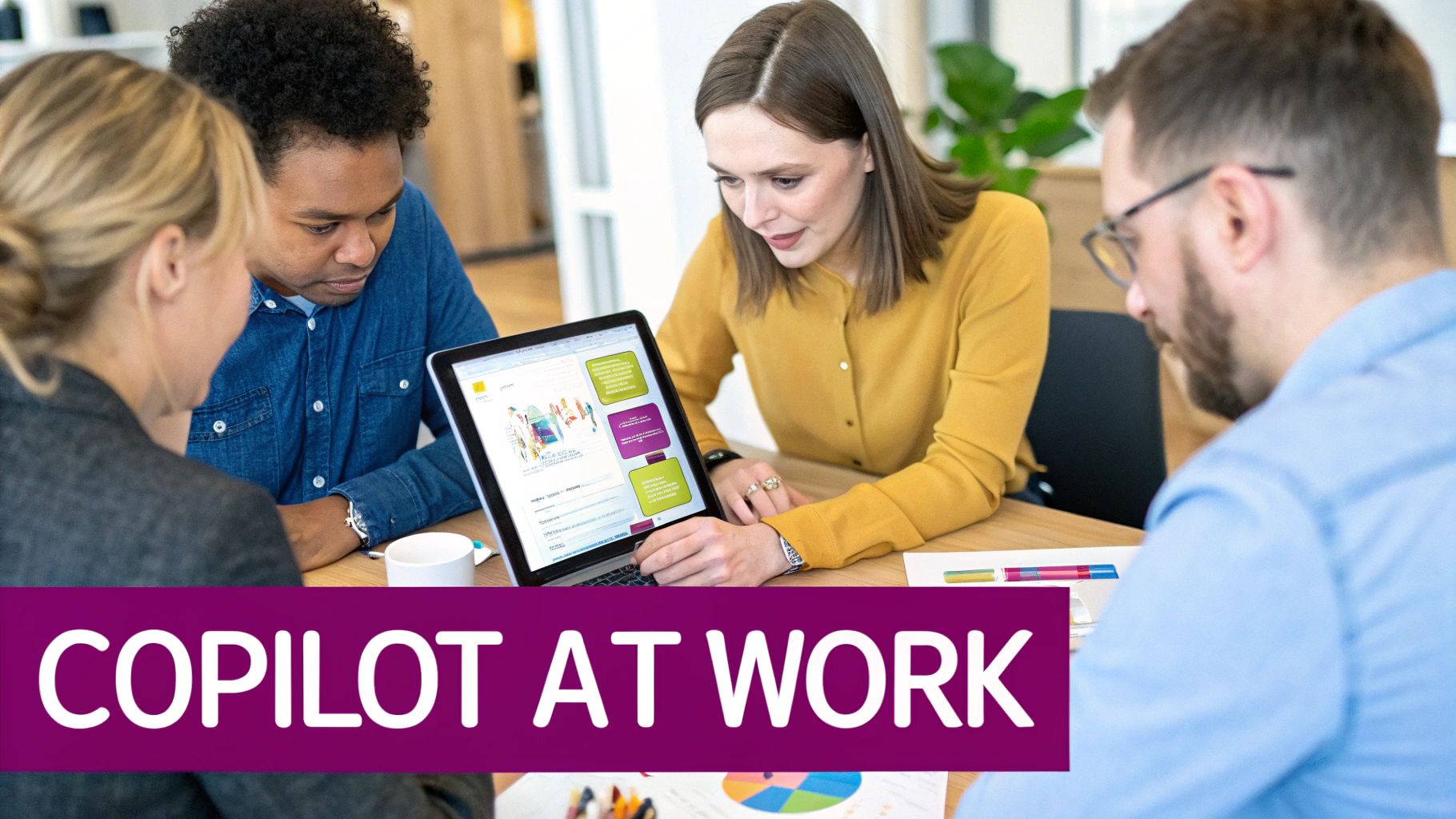 Four diverse colleagues collaborate around a laptop in an office, focusing on Copilot at Work.