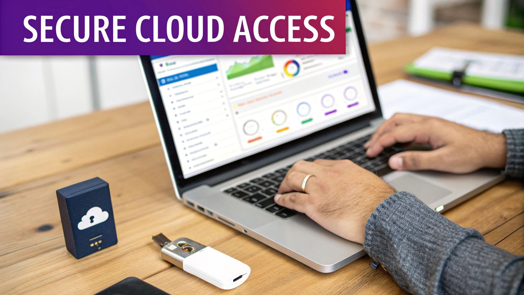 Hands typing on a laptop displaying a cloud dashboard, with secure cloud access devices on a wooden desk.