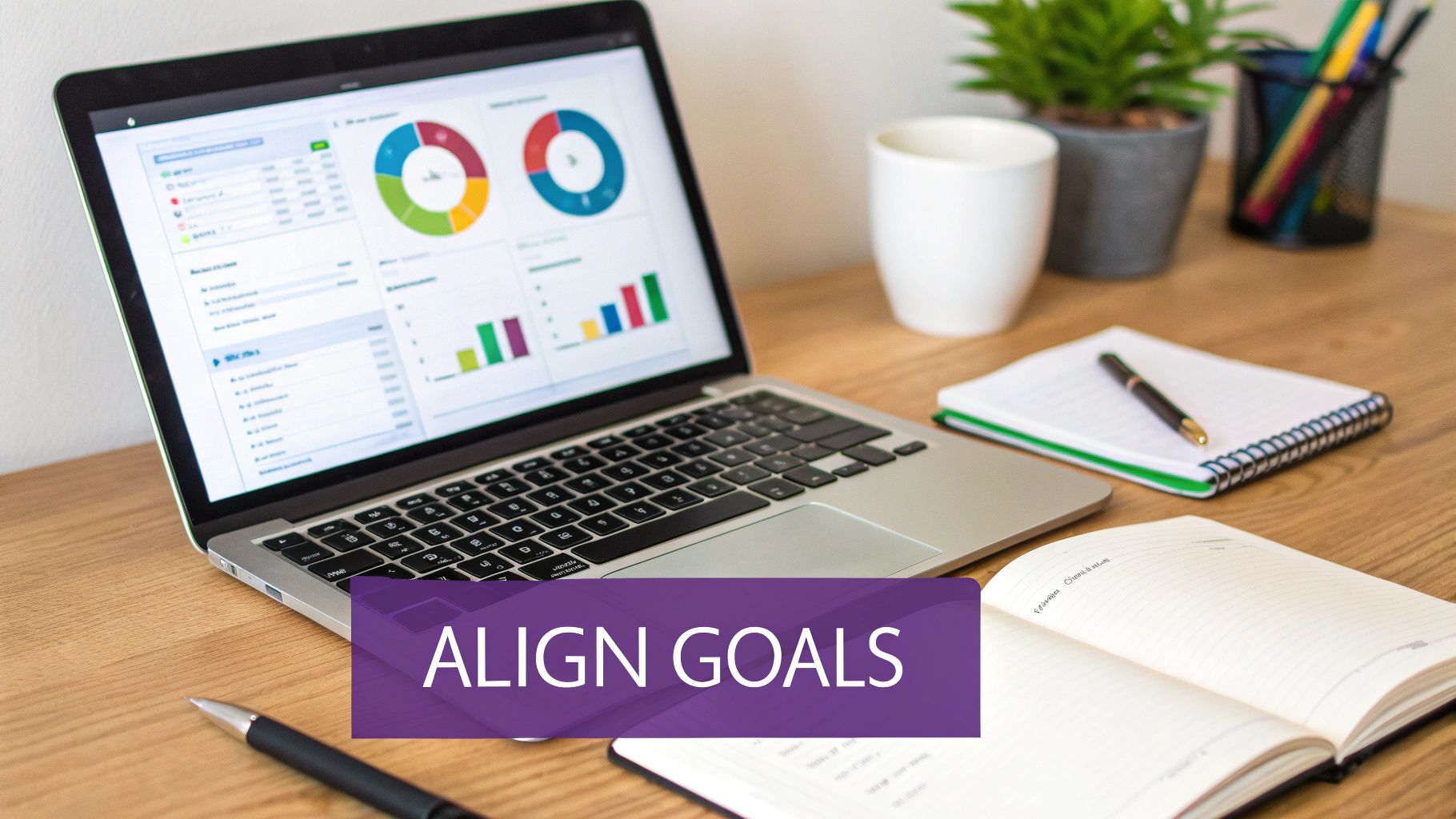 A laptop displaying colorful business analytics graphs and charts on a wooden desk with notebooks and pens.