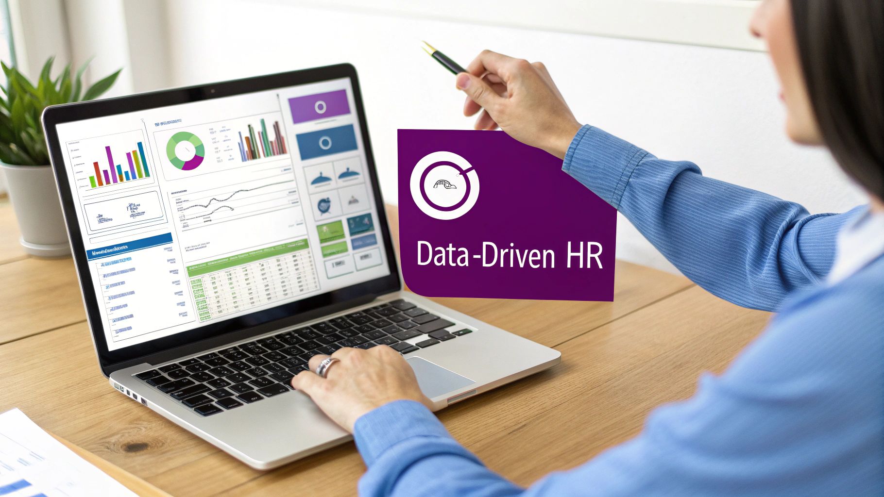 Person pointing at a 'Data-Driven HR' graphic while working on a laptop with analytics dashboards.