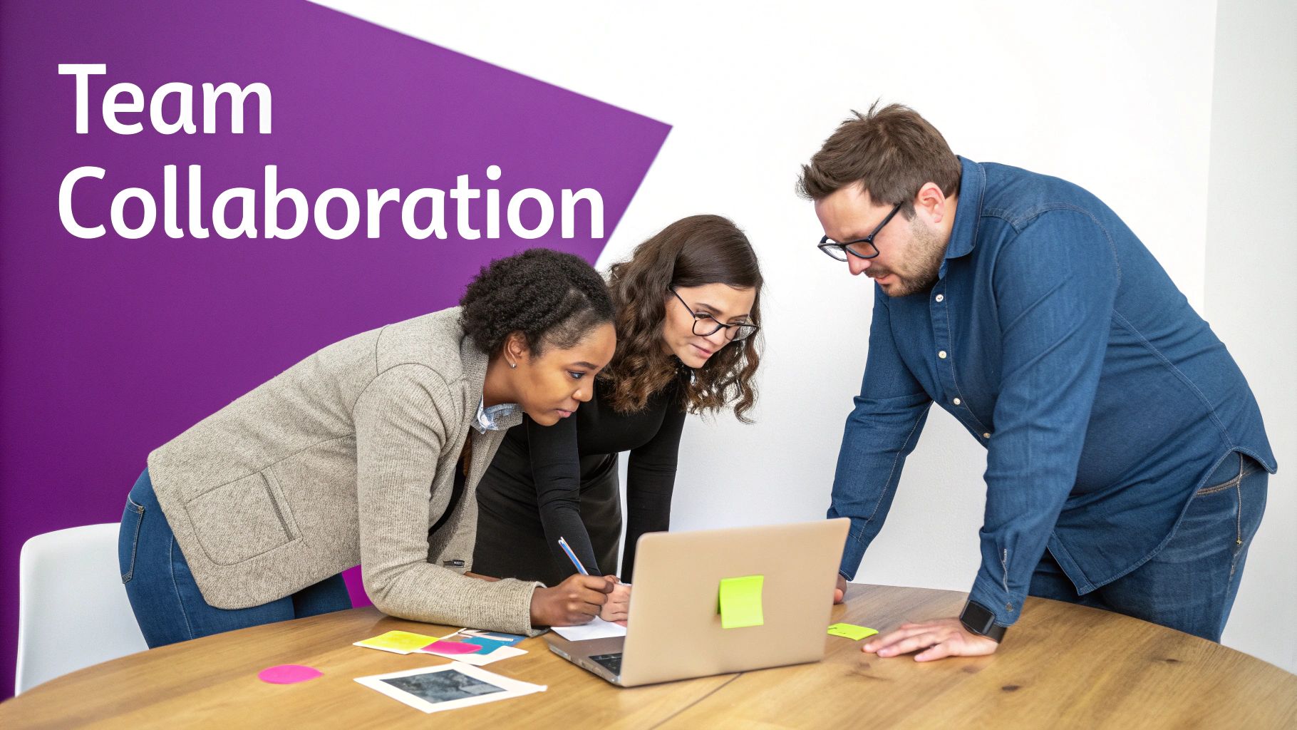 Three diverse professionals, two women and one man, actively collaborating around a laptop on a wooden table.