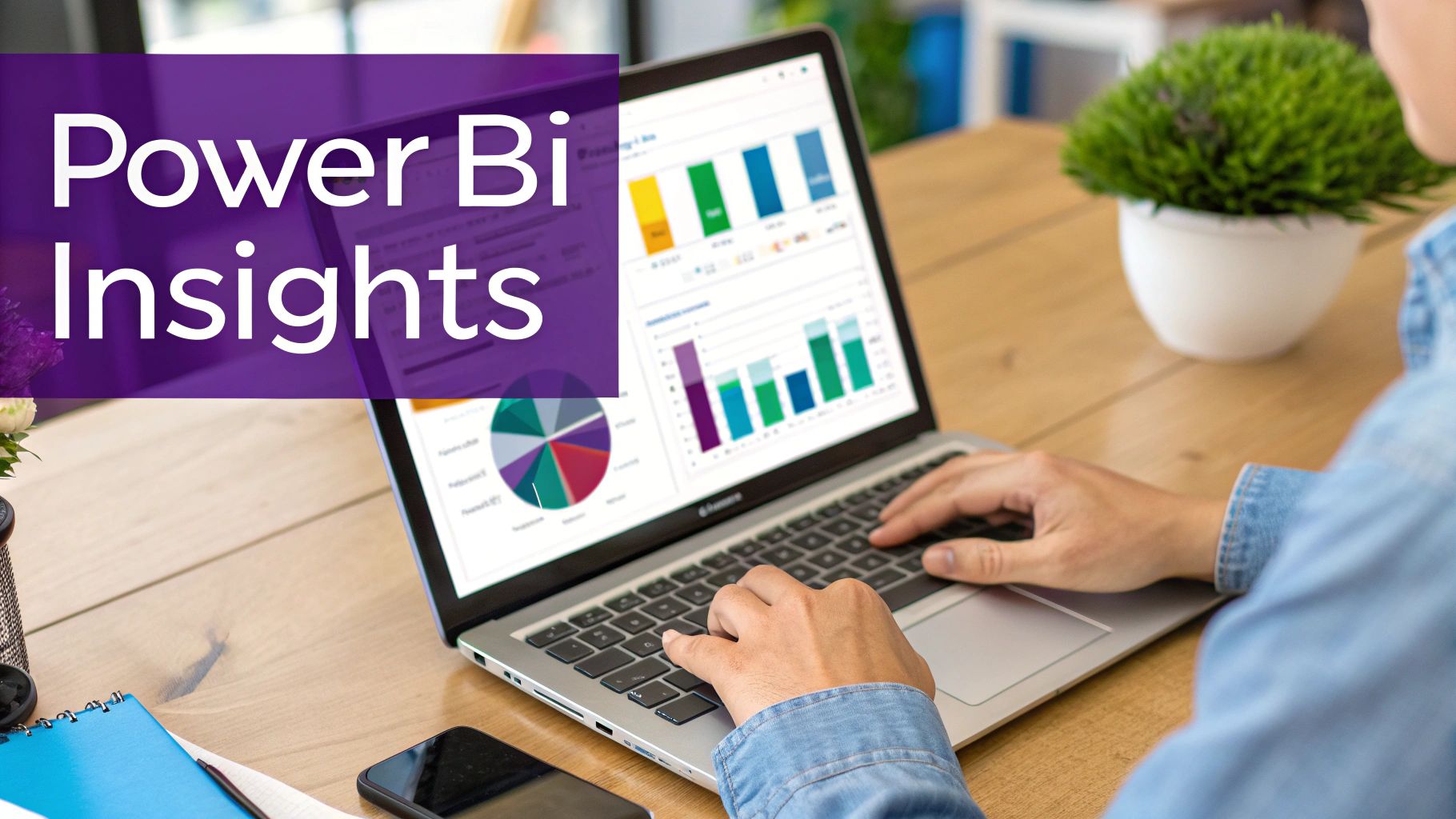 Person using Power BI Insights on laptop displaying colorful charts and data visualizations on wooden desk