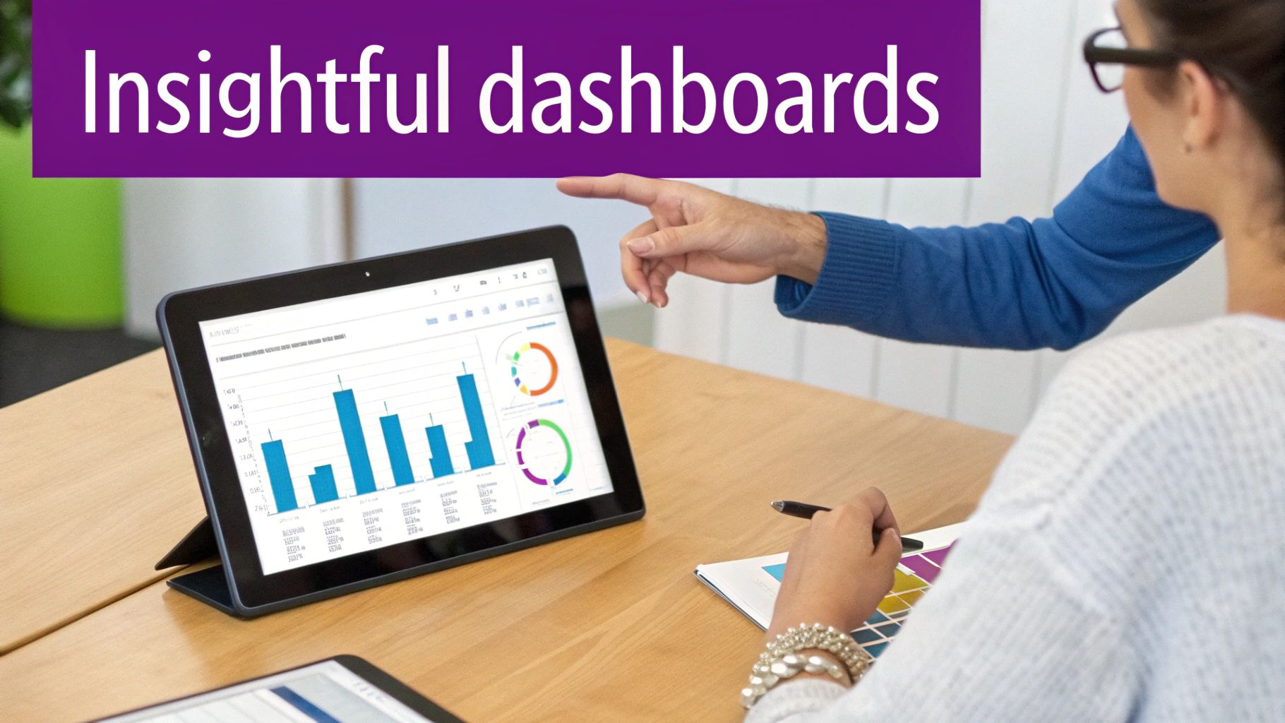Two people collaborating, reviewing insightful data dashboards with charts and graphs on a tablet.