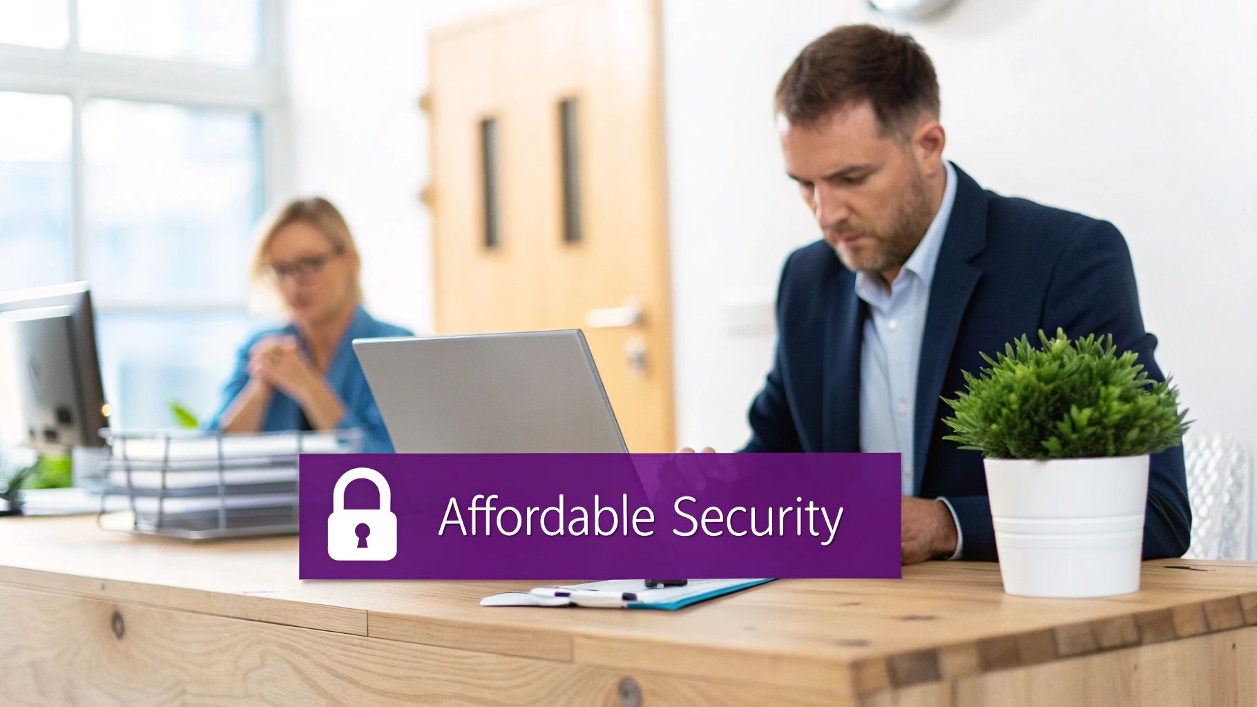 A man works on a laptop at a desk in an office, with an 'Affordable Security' banner.