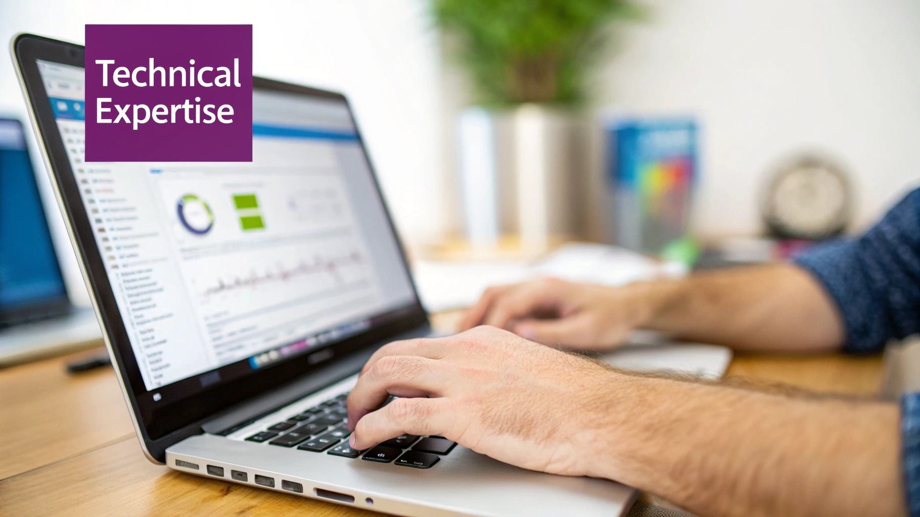 Close-up of hands typing on a laptop screen displaying data charts, highlighting technical expertise.