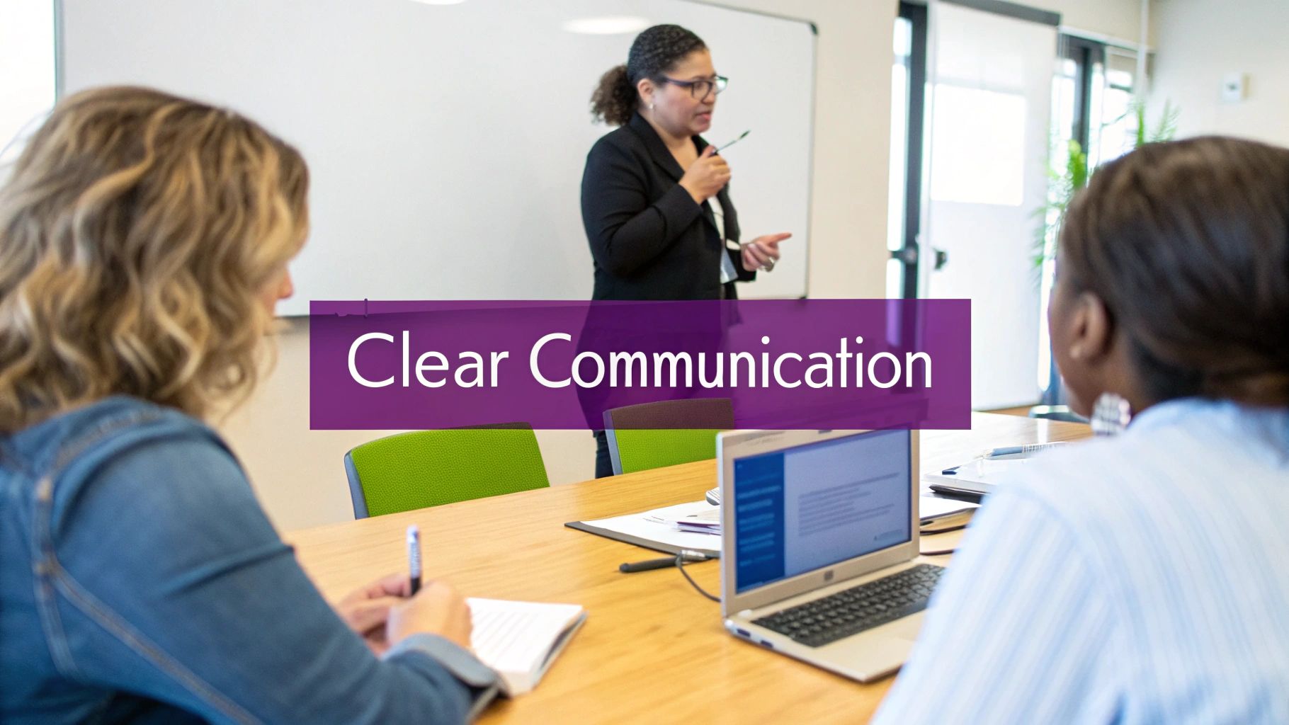 An African American woman presents to two attendees in a meeting, emphasizing clear communication.