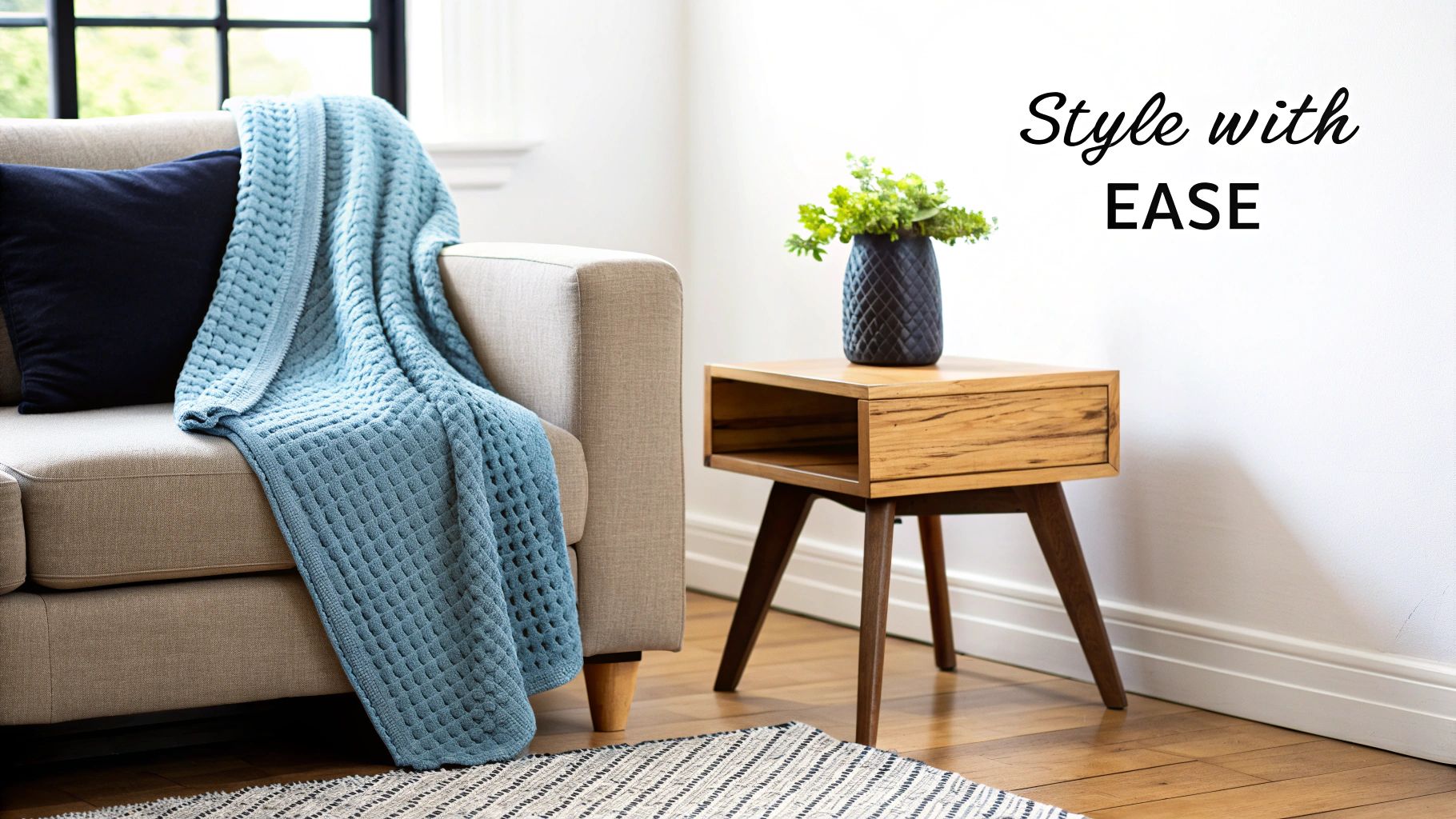 A stylish living room with a cotton blanket draped over a sofa