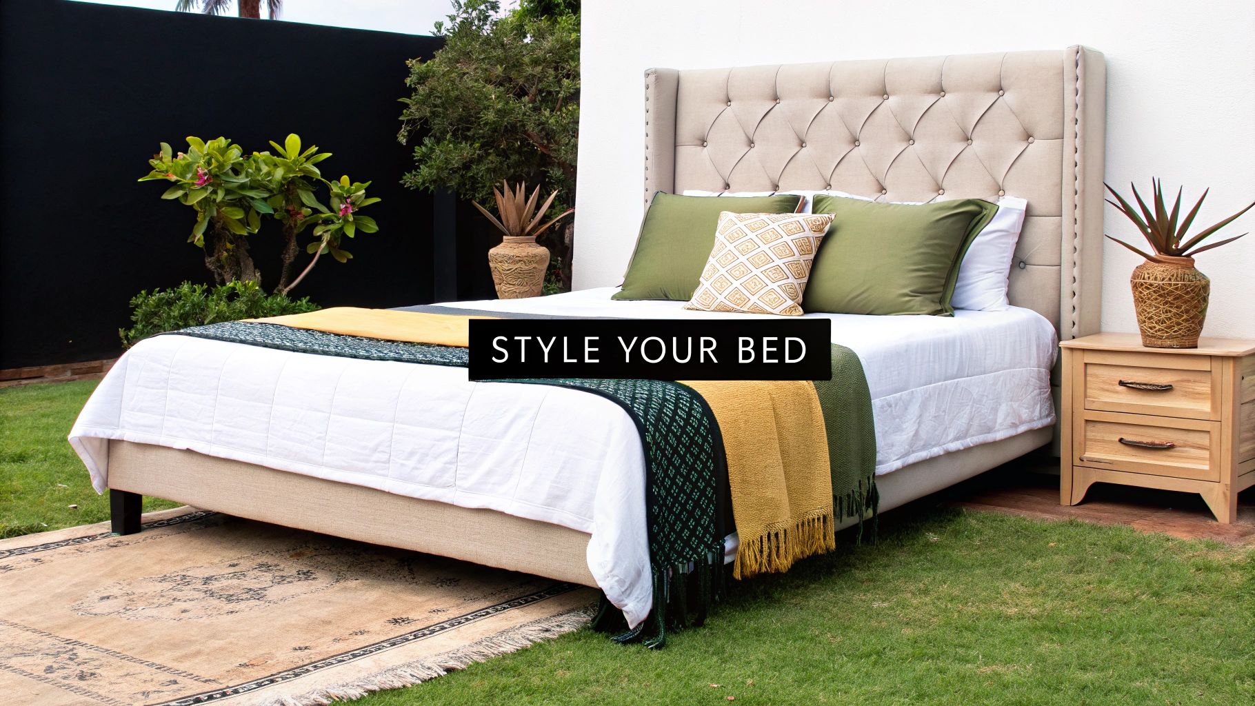 A beautifully styled bed with a white queen duvet cover, artfully arranged pillows, and a soft throw blanket.