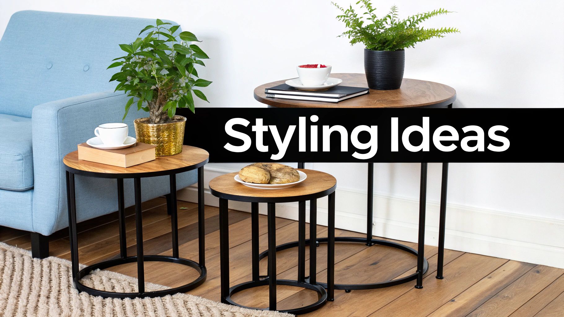Set of three round nesting tables with wooden tops and metal frames, adorned with plants and mugs.