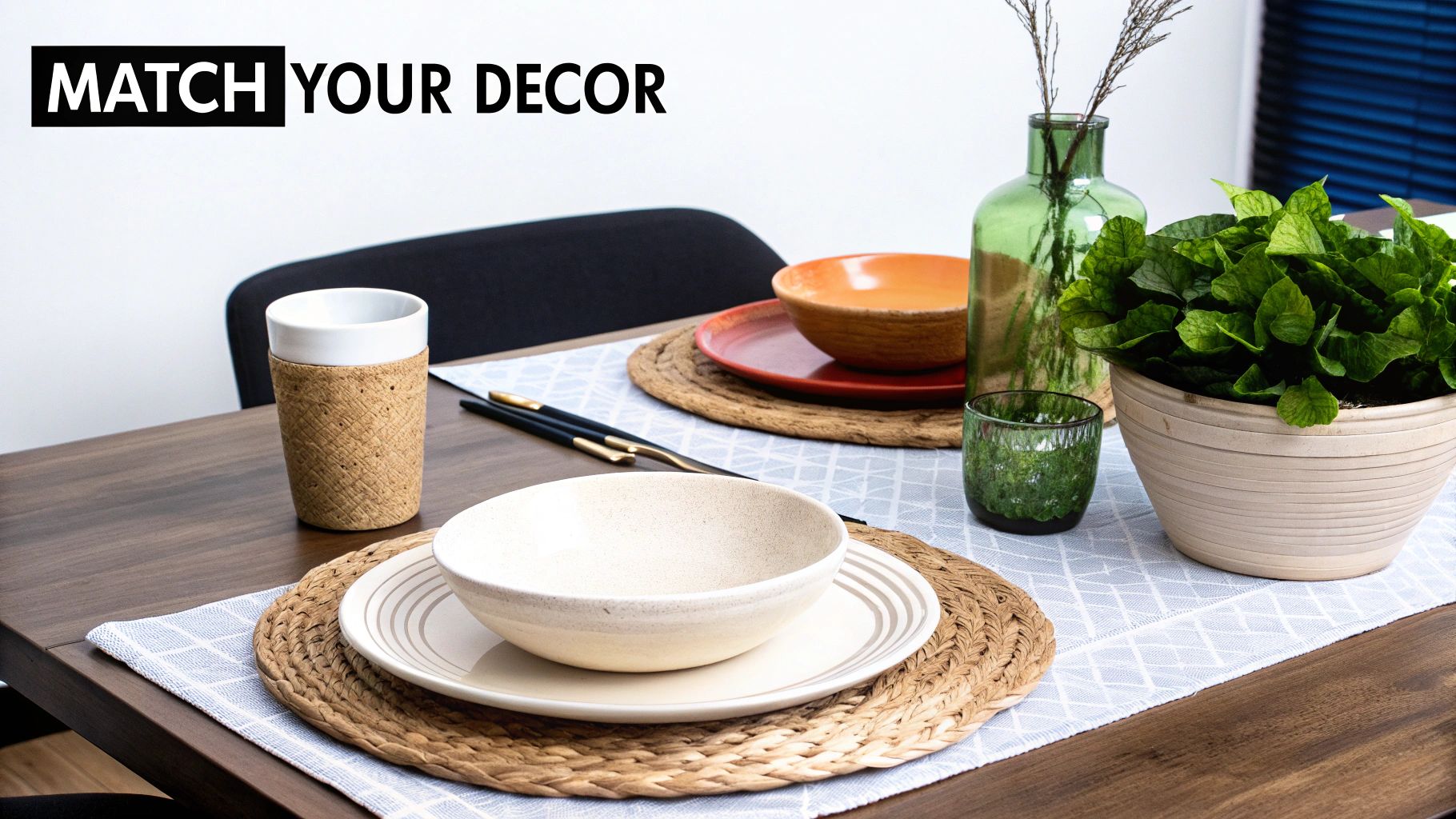 Dining table featuring natural woven placemats, ceramic dinnerware, a plant, and matching green glass decor.