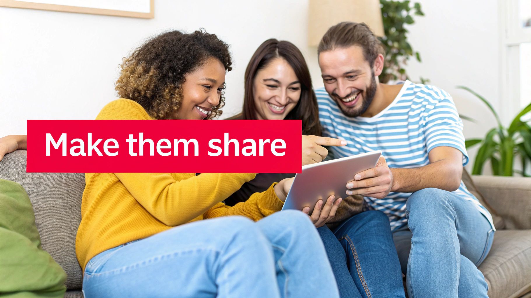 Smiling diverse young adults on a couch enjoying content together on a digital tablet.