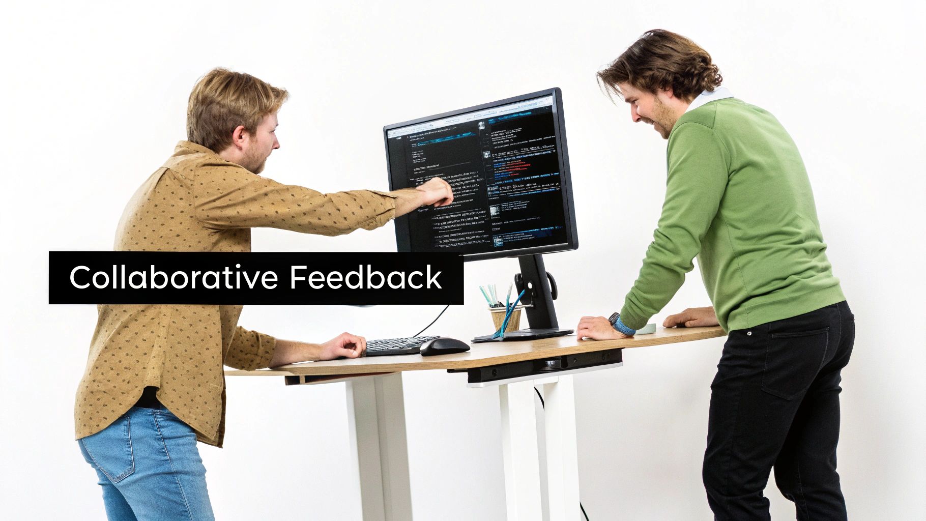 Two men providing collaborative feedback on code displayed on a computer screen at a standing desk.