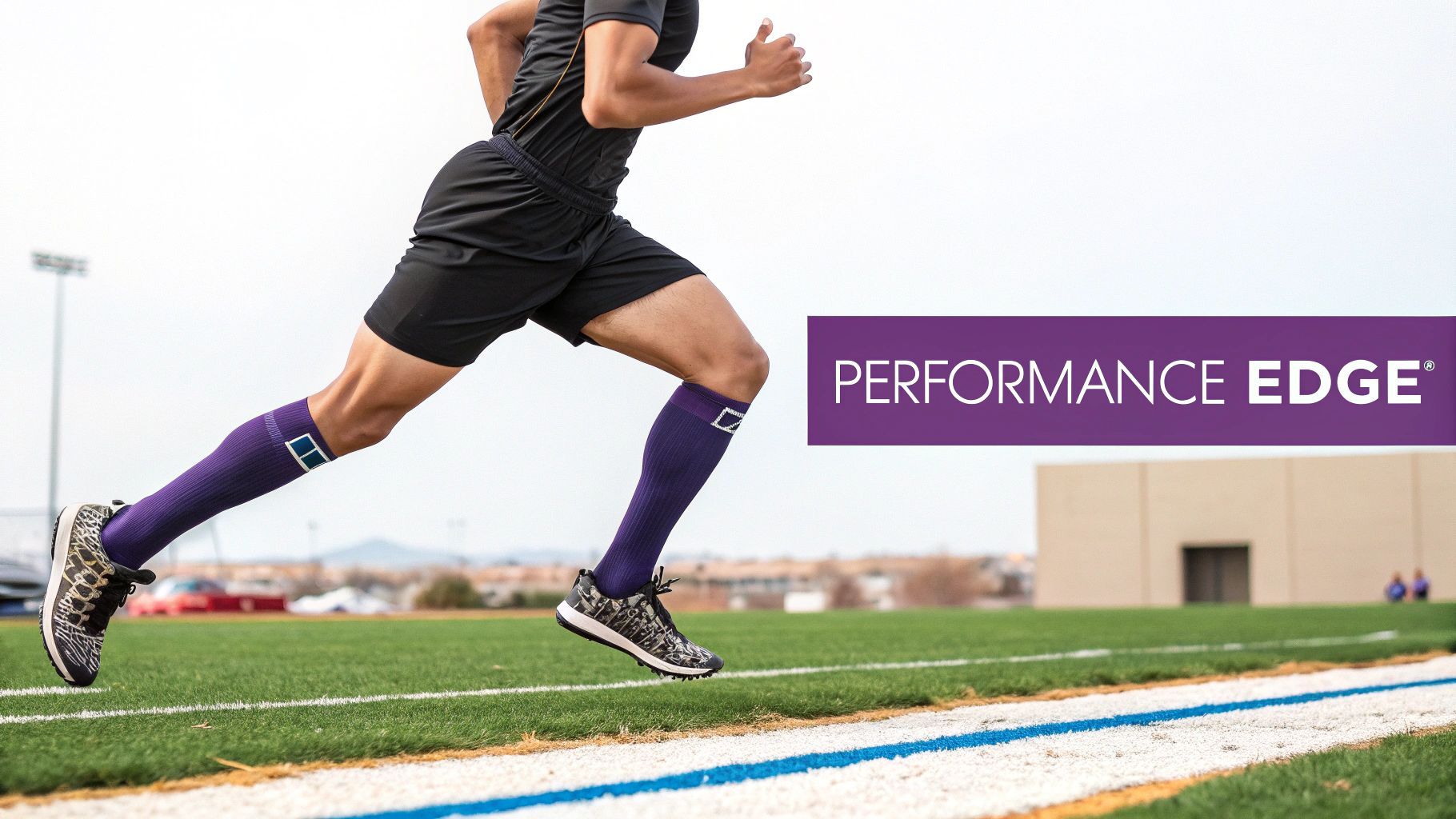 An athletic runner sprints on a green sports field, wearing black shorts and purple knee-high socks.
