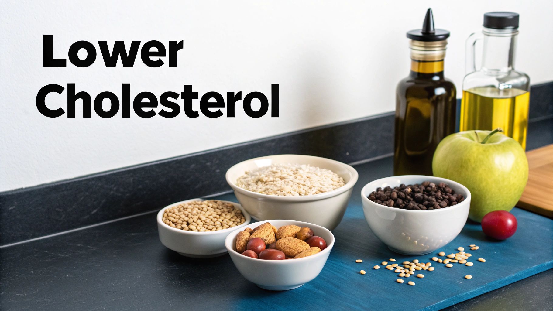A display of healthy foods like oats, lentils, nuts, beans, fruit, and olive oil to lower cholesterol.
