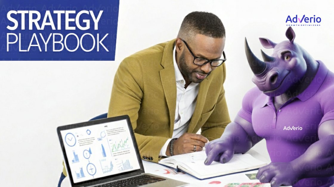 A man and a purple rhinoceros mascot discuss a strategy playbook, with a laptop showing data charts.