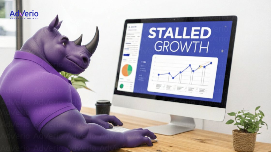 A Strategic Guide to Amazon Seller Central Advertising for Intermediate Sellers 3 Animated purple rhino character at a desk, looking at a monitor displaying "Stalled Growth" business data.
