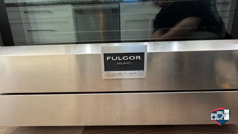 Close-up of a stainless steel Fulgor Milano oven with a glass door showing interior racks.