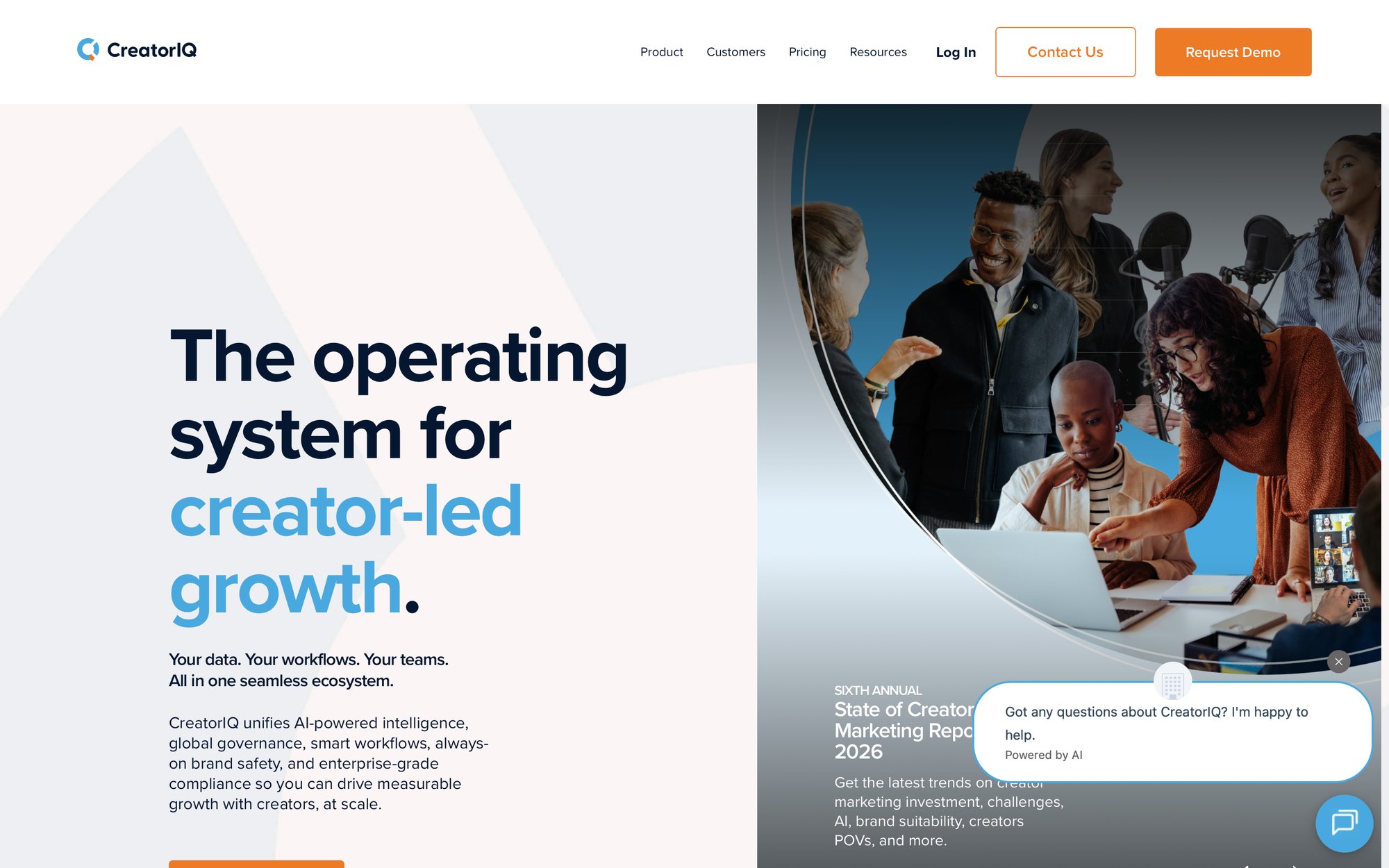 A diverse group of people collaborating around laptops and microphones in a modern office setting.