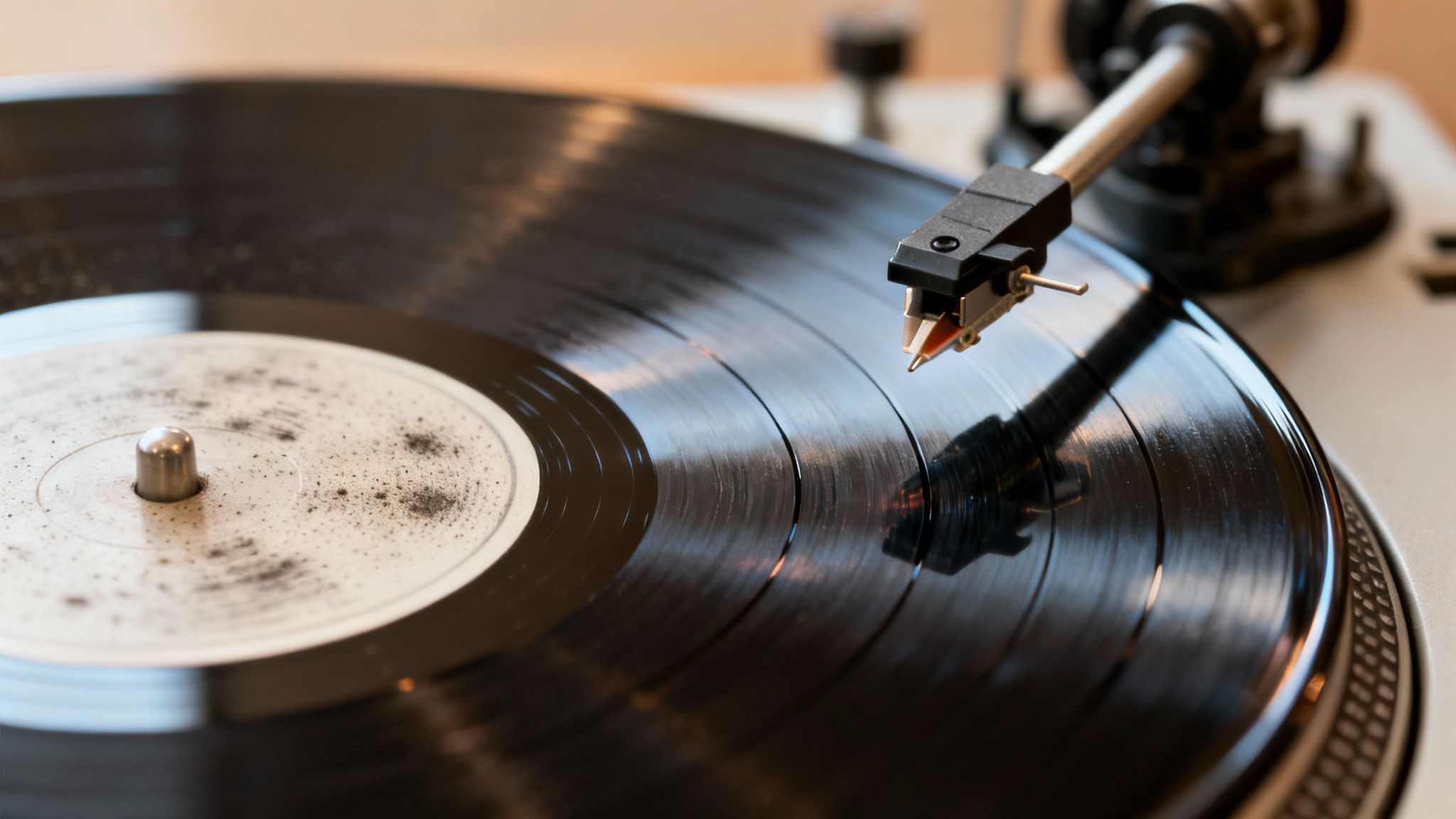 Close-up of a dusty vinyl record on a turntable with the stylus poised to play music.