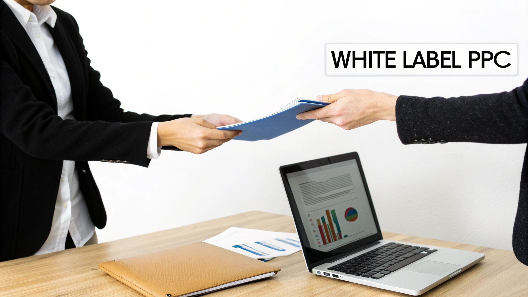 Two business people exchange blue documents on a desk with a laptop and a "WHITE LABEL PPC" sign.