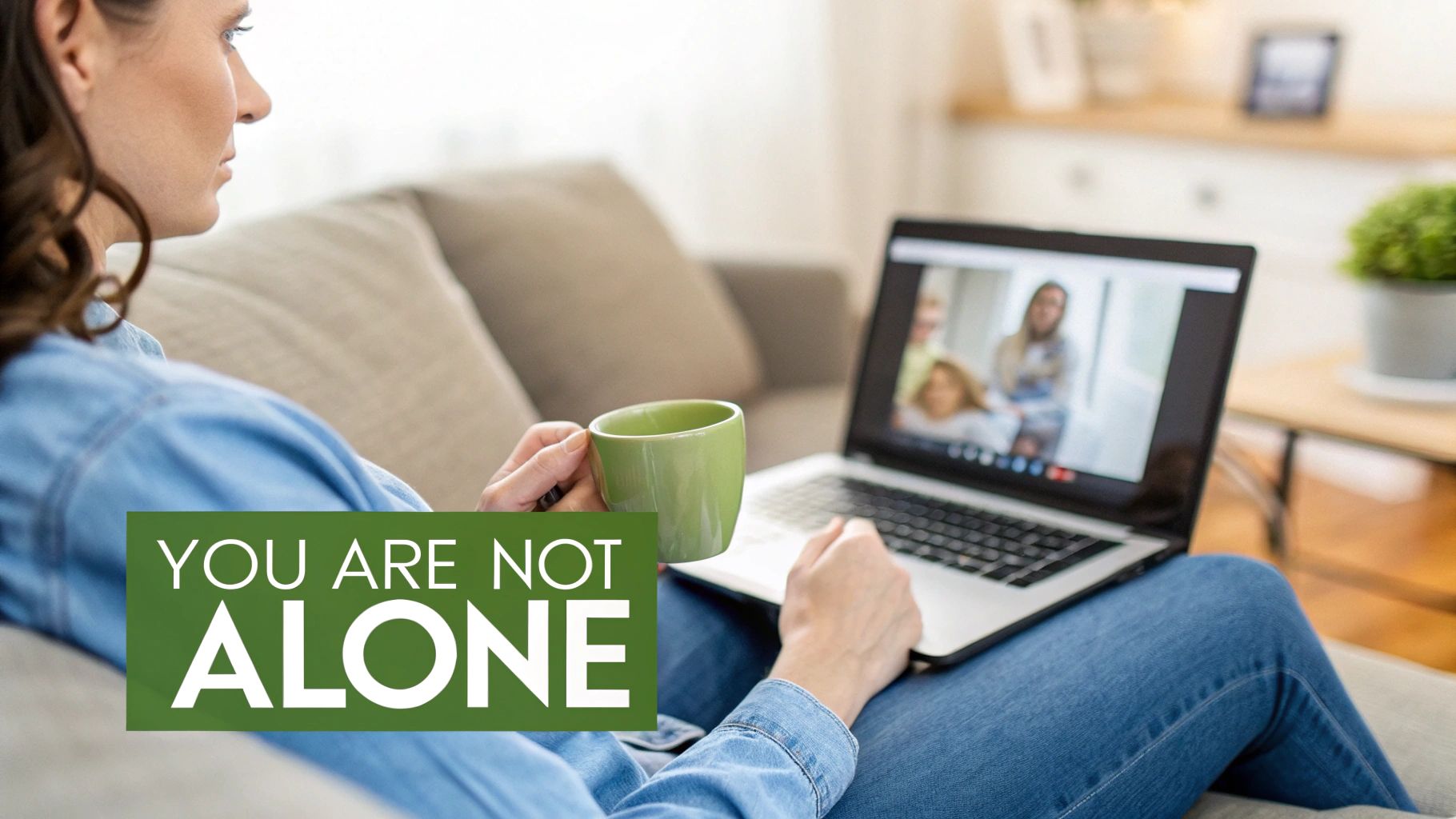 Woman on couch having a video call with multiple people on her laptop, holding a green mug, with text 