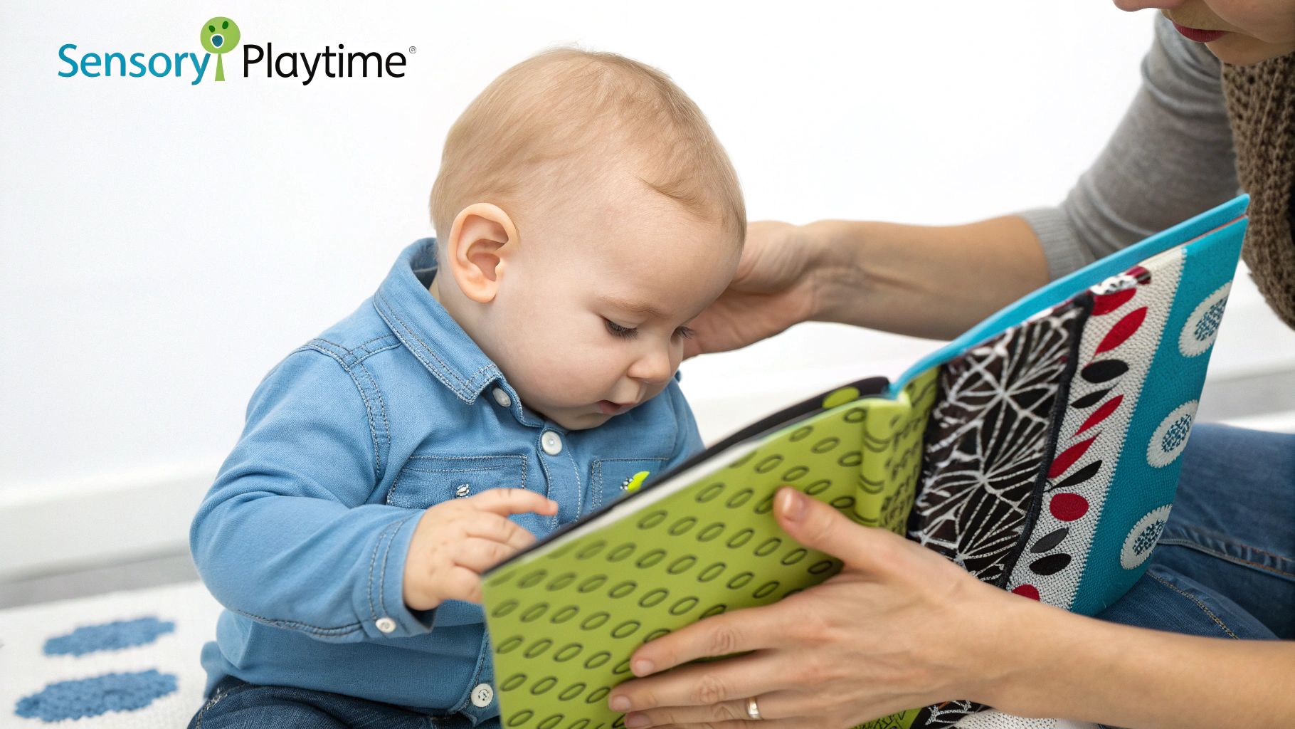 A baby reaching for a soft, high-contrast sensory book.