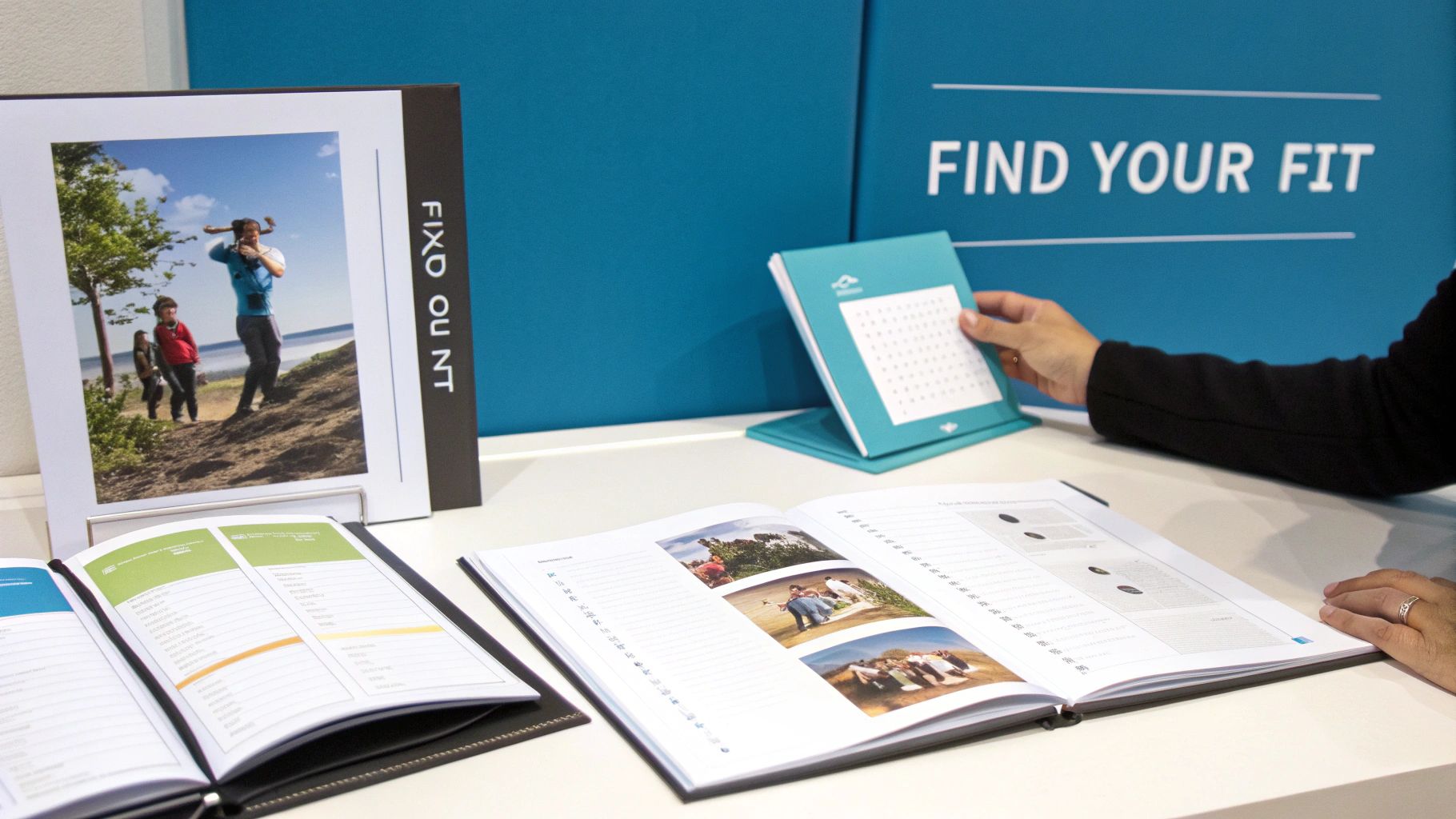 Two parents looking at a baby memory book on a couch