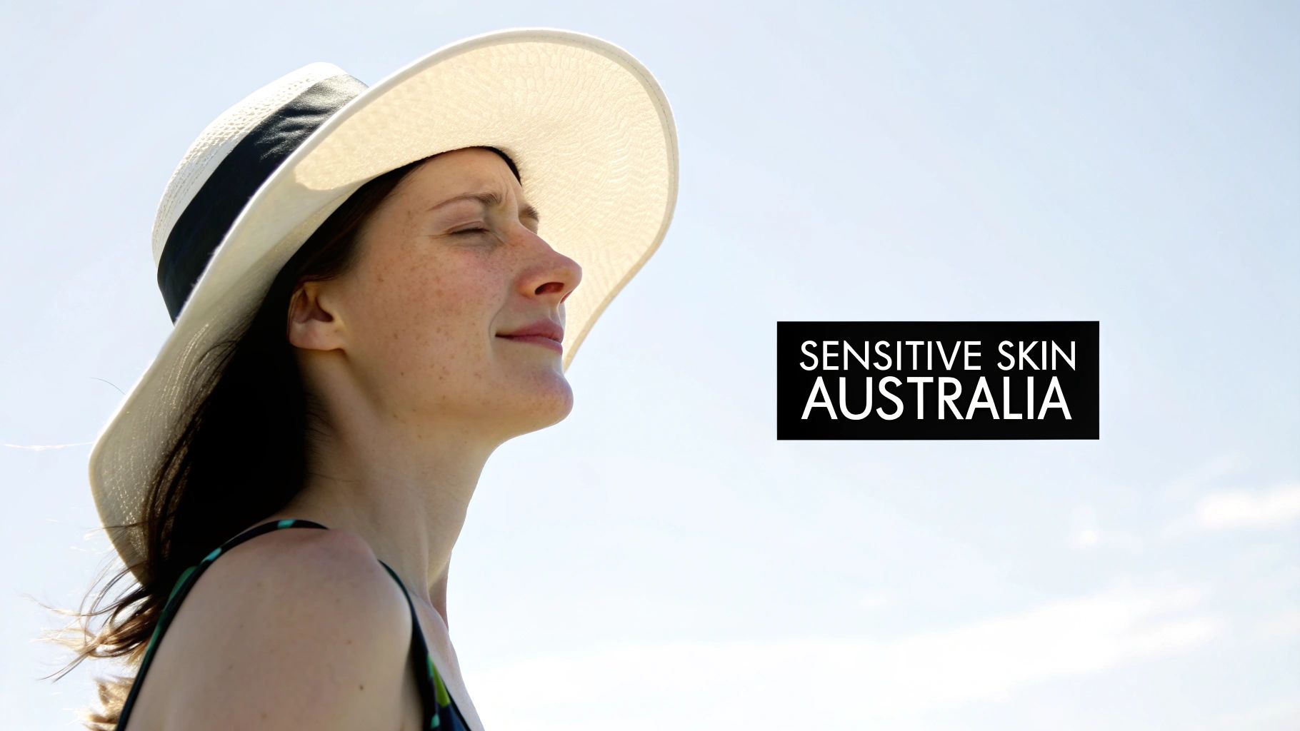 A woman with freckles wears a sun hat, eyes closed, enjoying sun, with 'SENSITIVE SKIN AUSTRALIA' text.