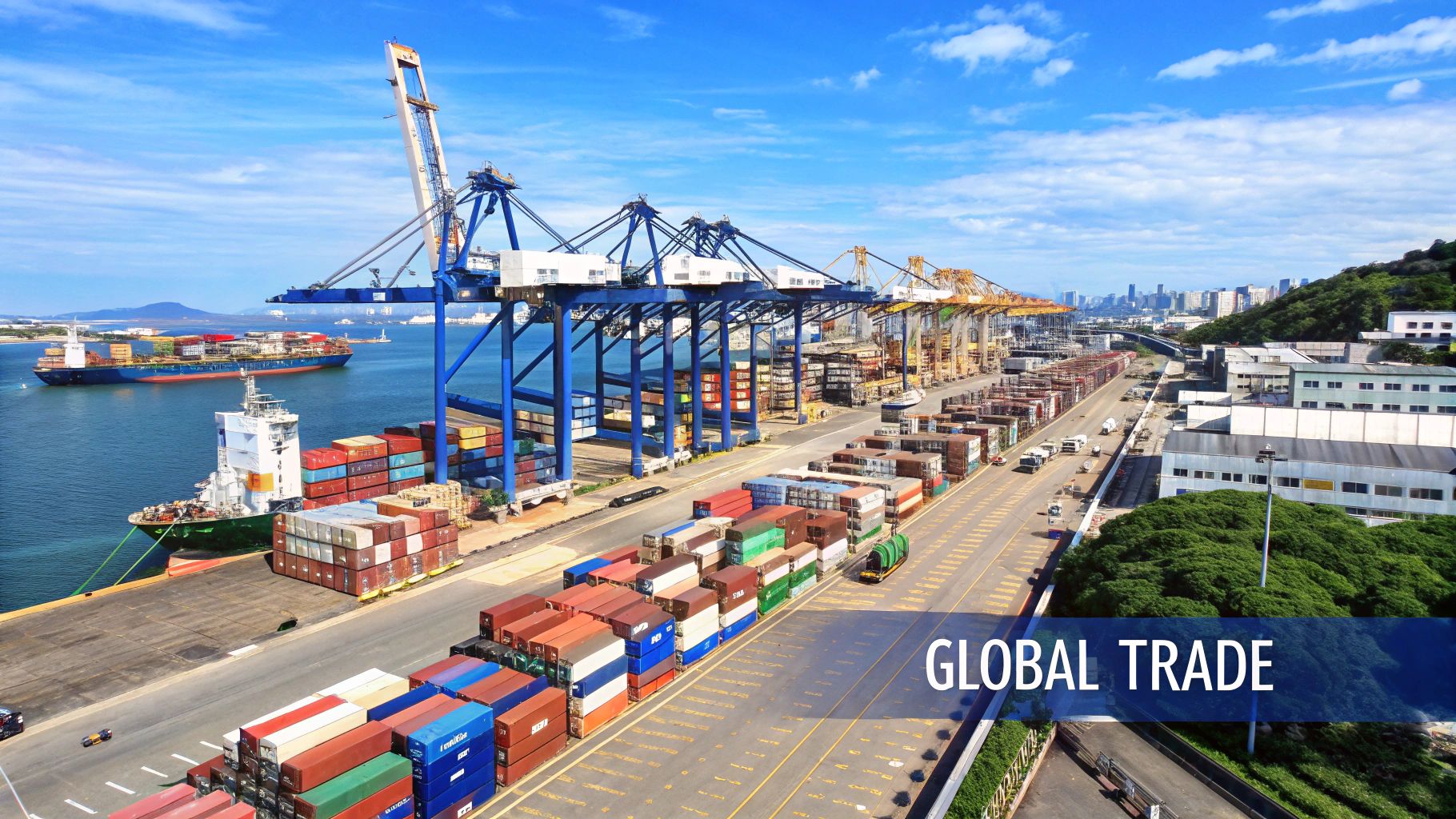 Aerial view of a busy container port with cargo ships, cranes, and stacks of colorful containers.