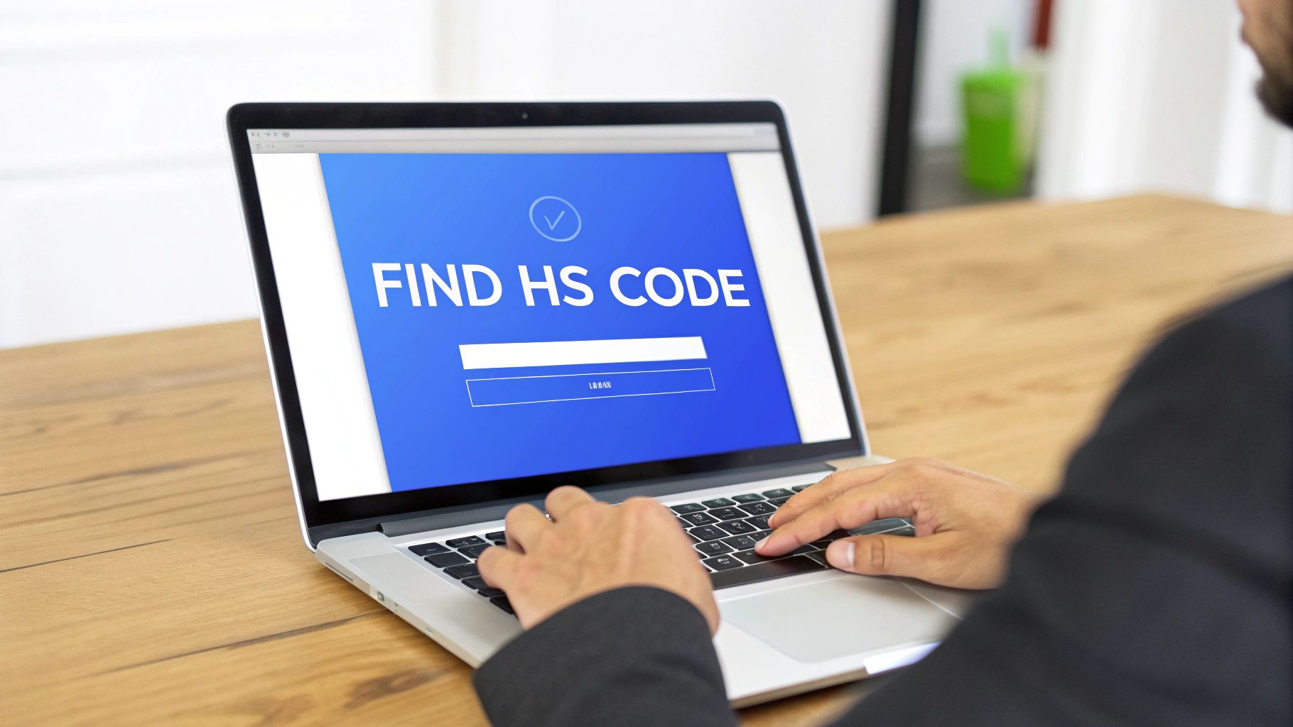 A person types on a laptop screen displaying 'FIND HS CODE' for product classification.