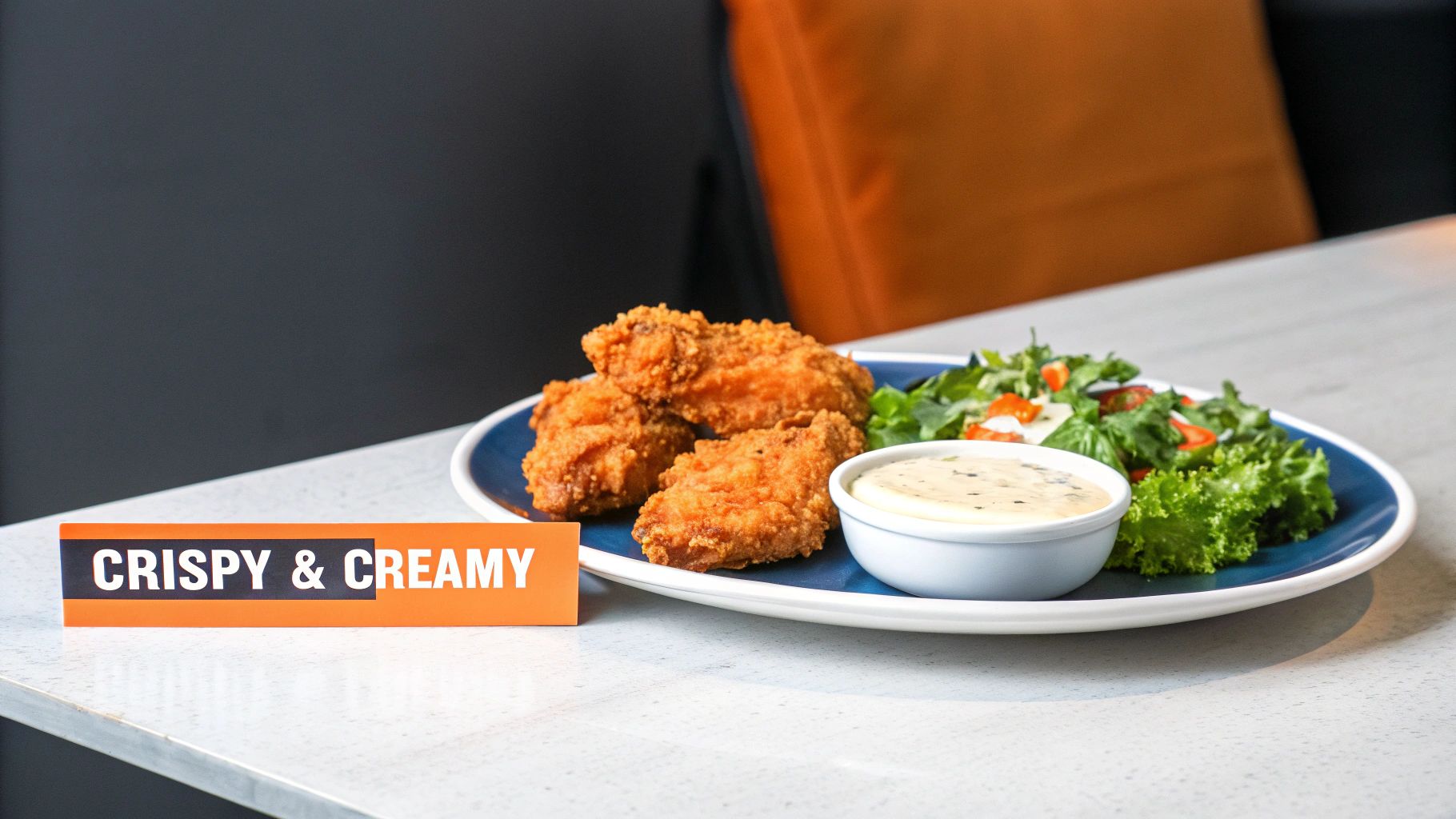 A hand sprinkling FryAway powder into a pan of hot cooking oil.