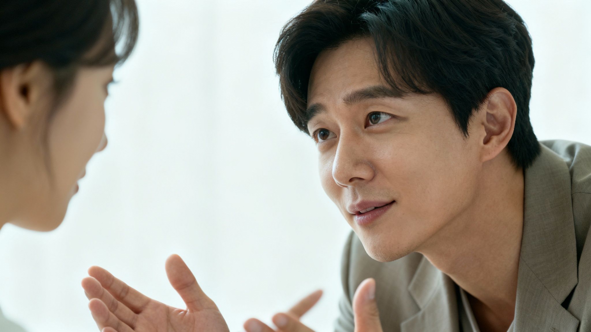 Man and woman in a professional setting, actively discussing, possibly resolving a workplace conflict.