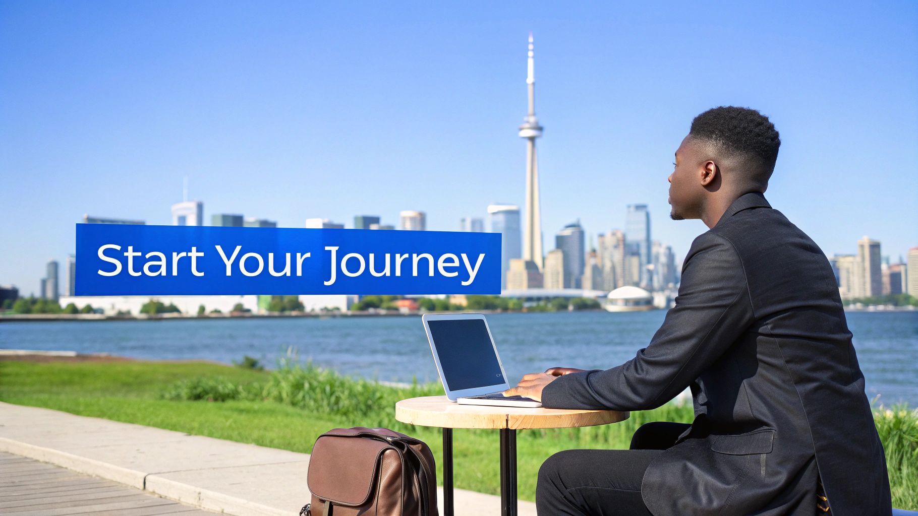 Professional businessman working on laptop outdoors with Toronto skyline and CN Tower in background