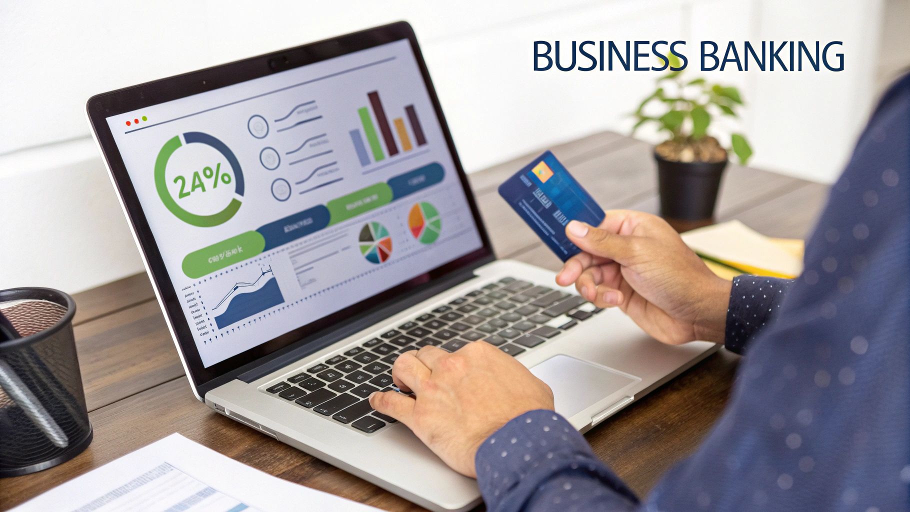 An assortment of business and finance-related items on a desk, including a calculator, a business checking account book, a pen, a credit card, and a smartphone displaying a banking app. The scene is well-lit and professional, symbolizing the process of setting up business financial systems.