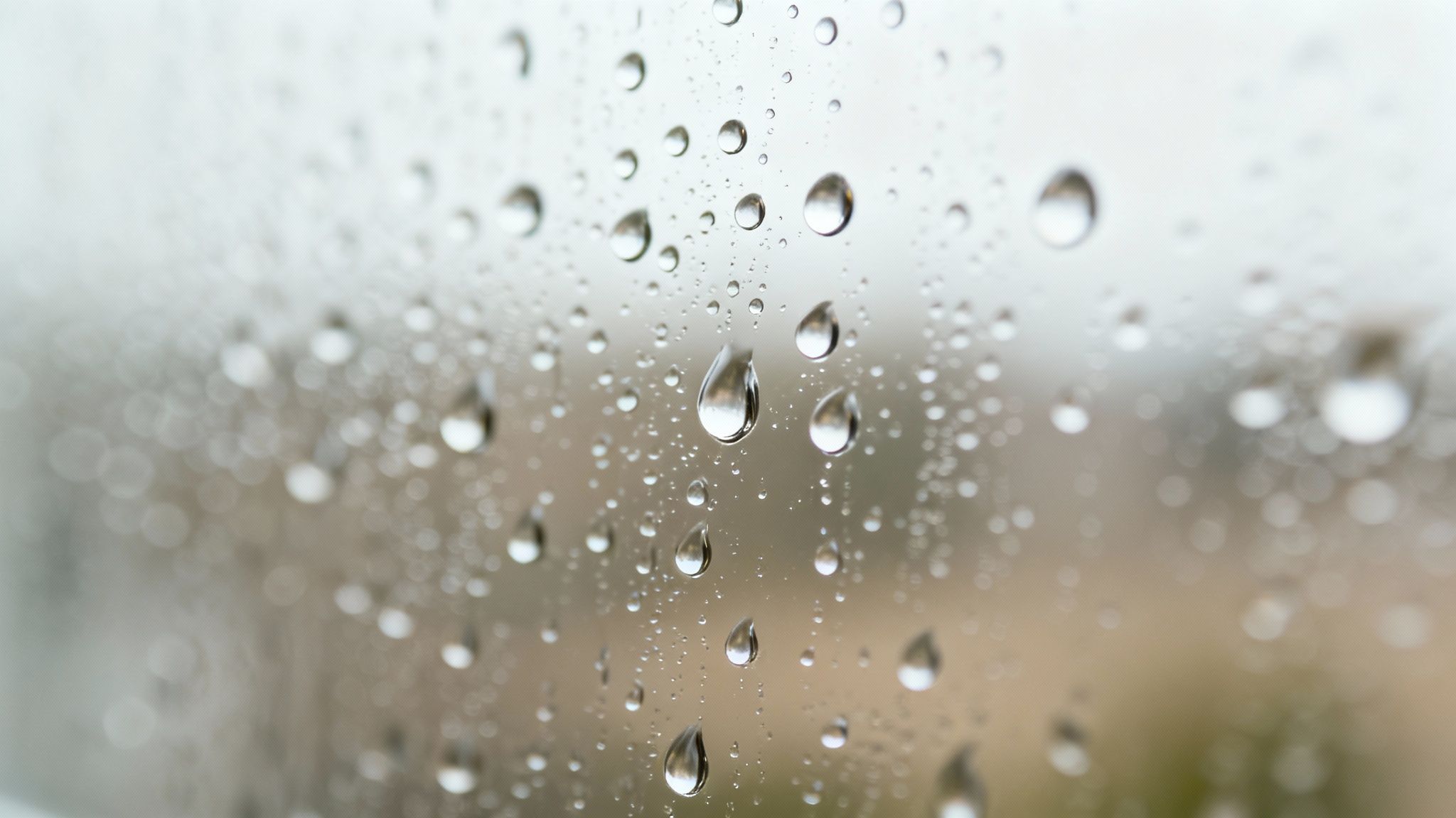 A hydrophobic coating causing water to bead up and roll off a clean window.