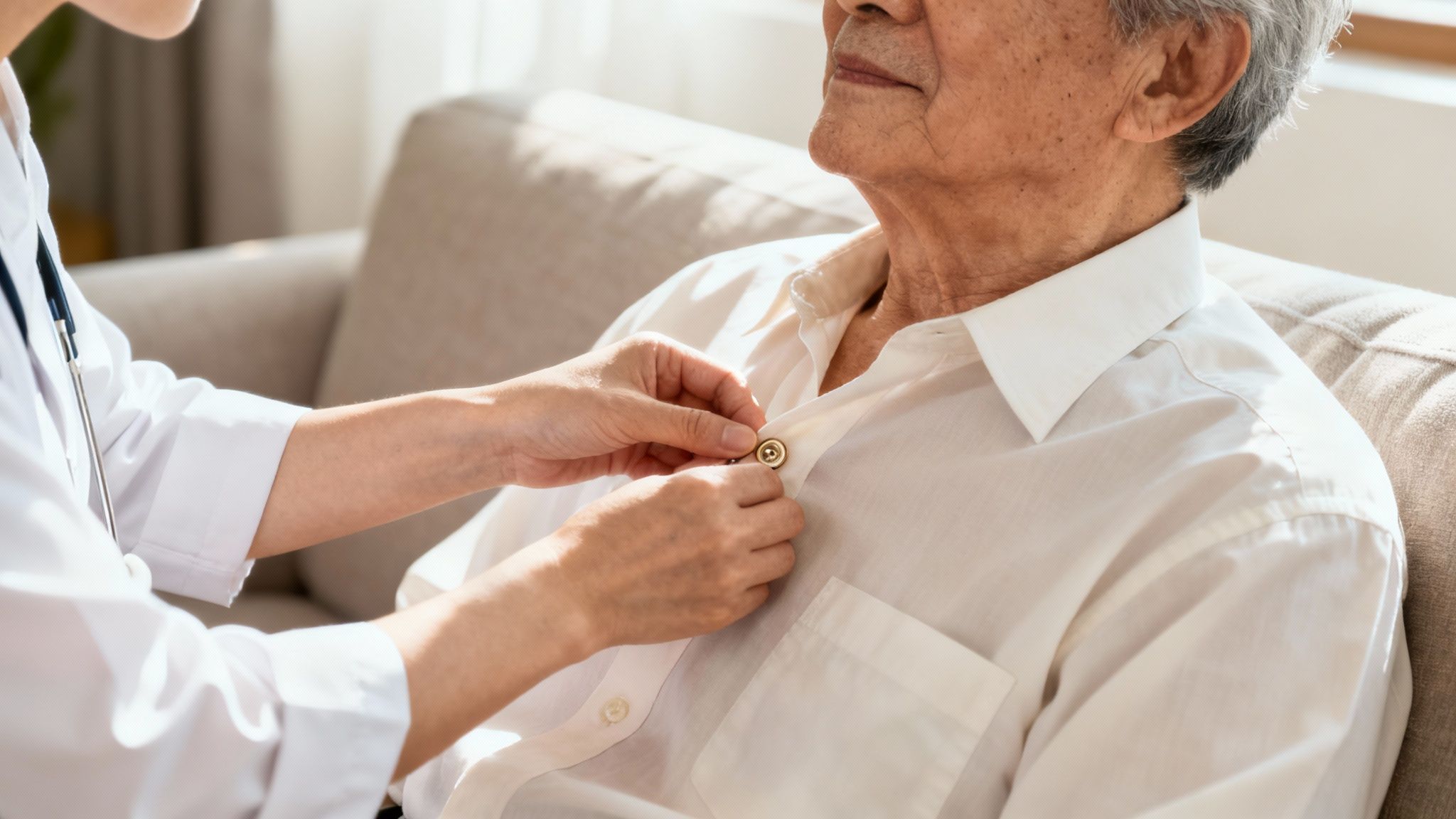 Caregiver helps a senior with mobility in her home.