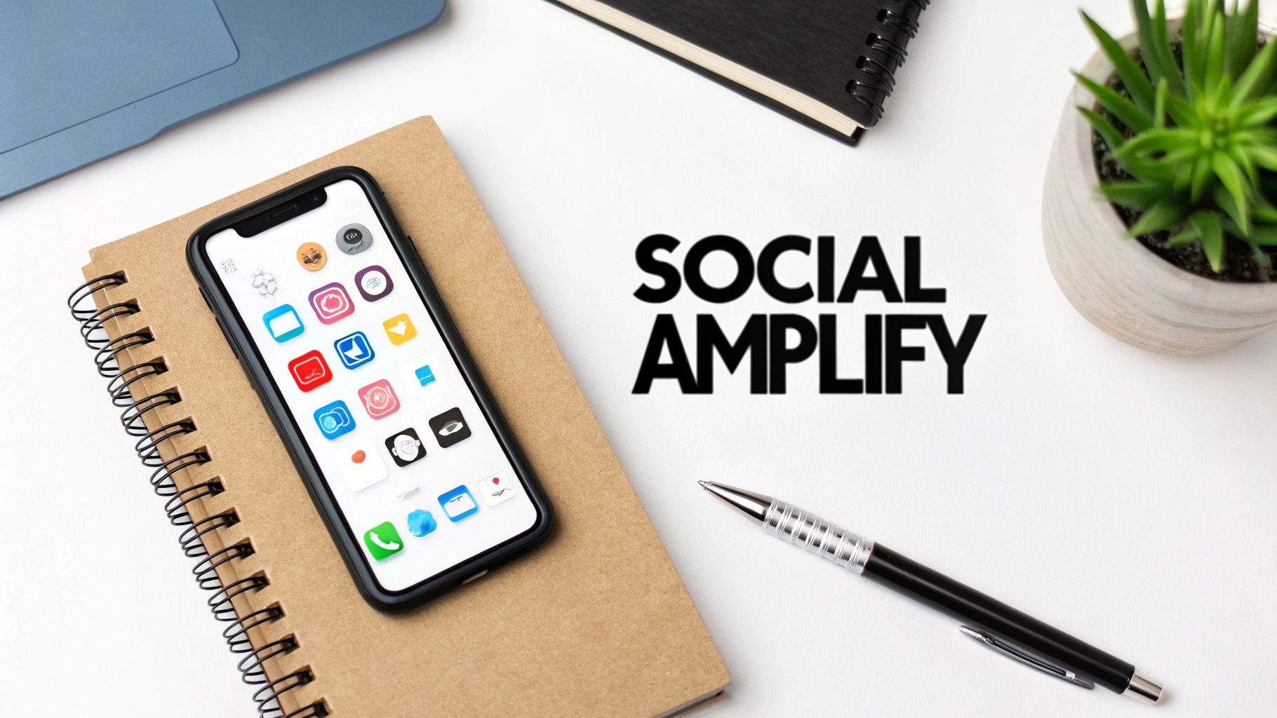 Social media amplify concept with smartphone displaying apps on notebook and desk workspace
