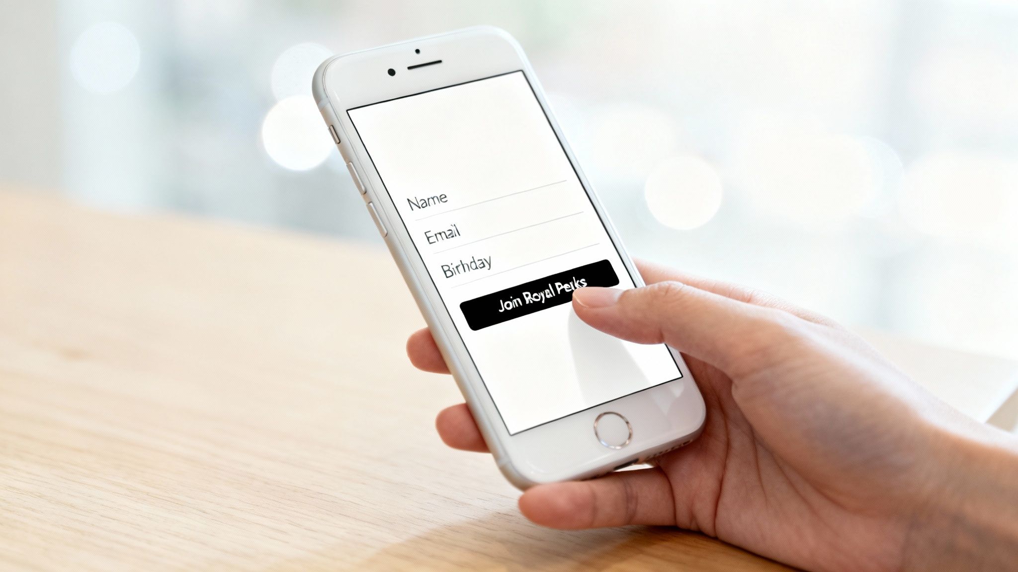 Your Guide to Burger King Birthday Freebies 2 Person using smartphone to join Royal Perks loyalty program with name, email, and birthday fields