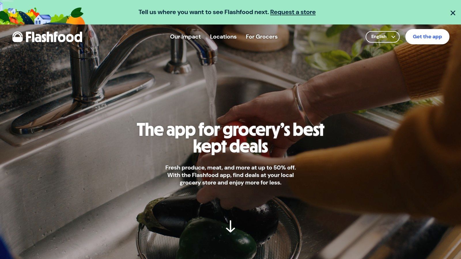 A person washing fresh vegetables like carrots and bell peppers in a kitchen sink, representing groceries obtained through Flashfood.