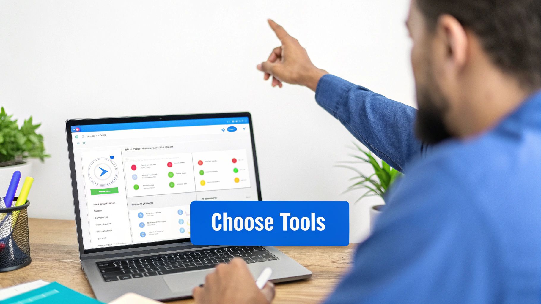 Man pointing, working on a laptop displaying project management software with 'Choose Tools' button.