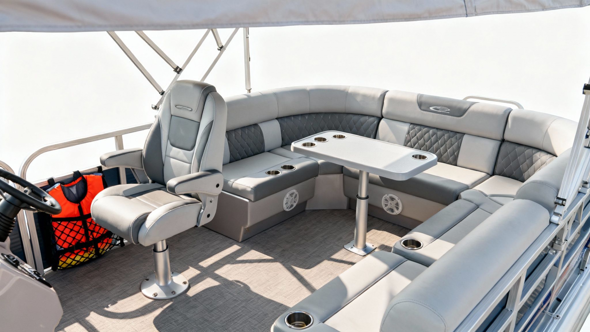 A relaxing pontoon setup with comfortable seating and a bimini top providing shade
