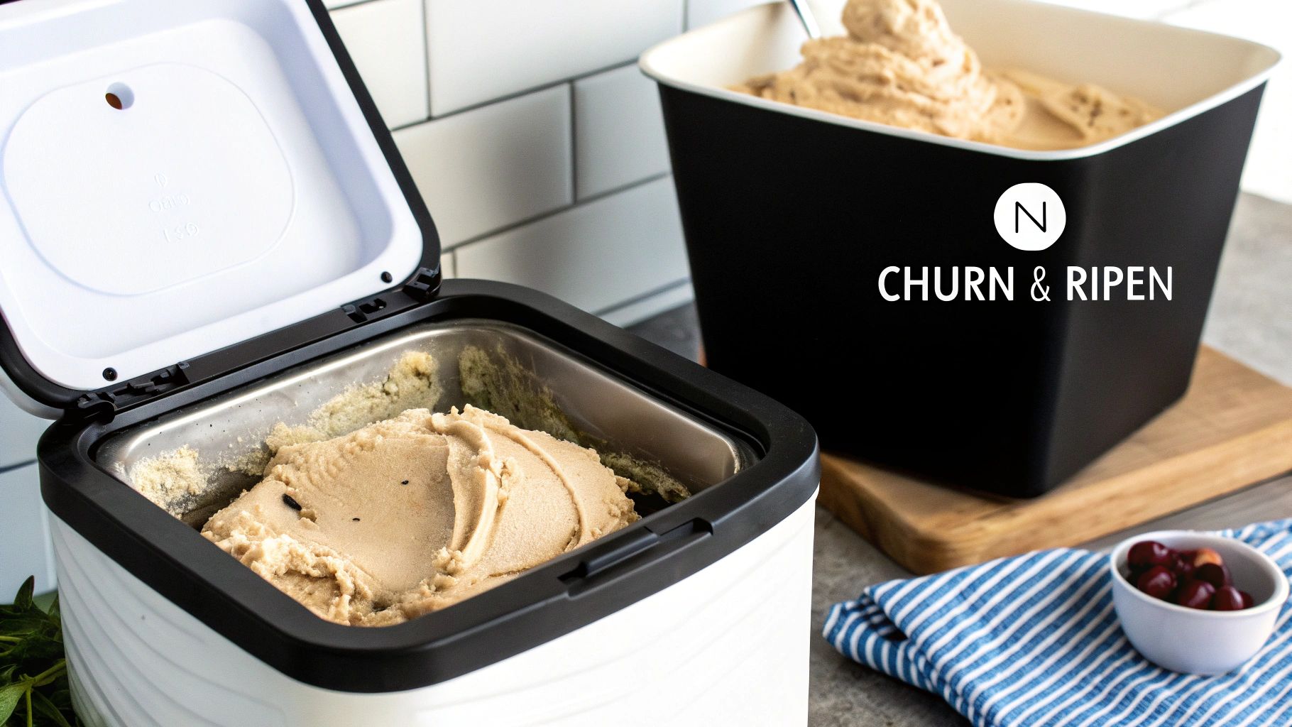 Homemade ice cream in a white ice cream maker and a black storage container with cherries.