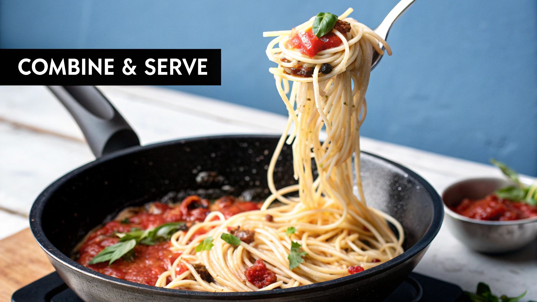 Pasta with tomato sauce is lifted by a fork over a black pan. Text reads "COMBINE & SERVE." Blue wall and bowl in the background.